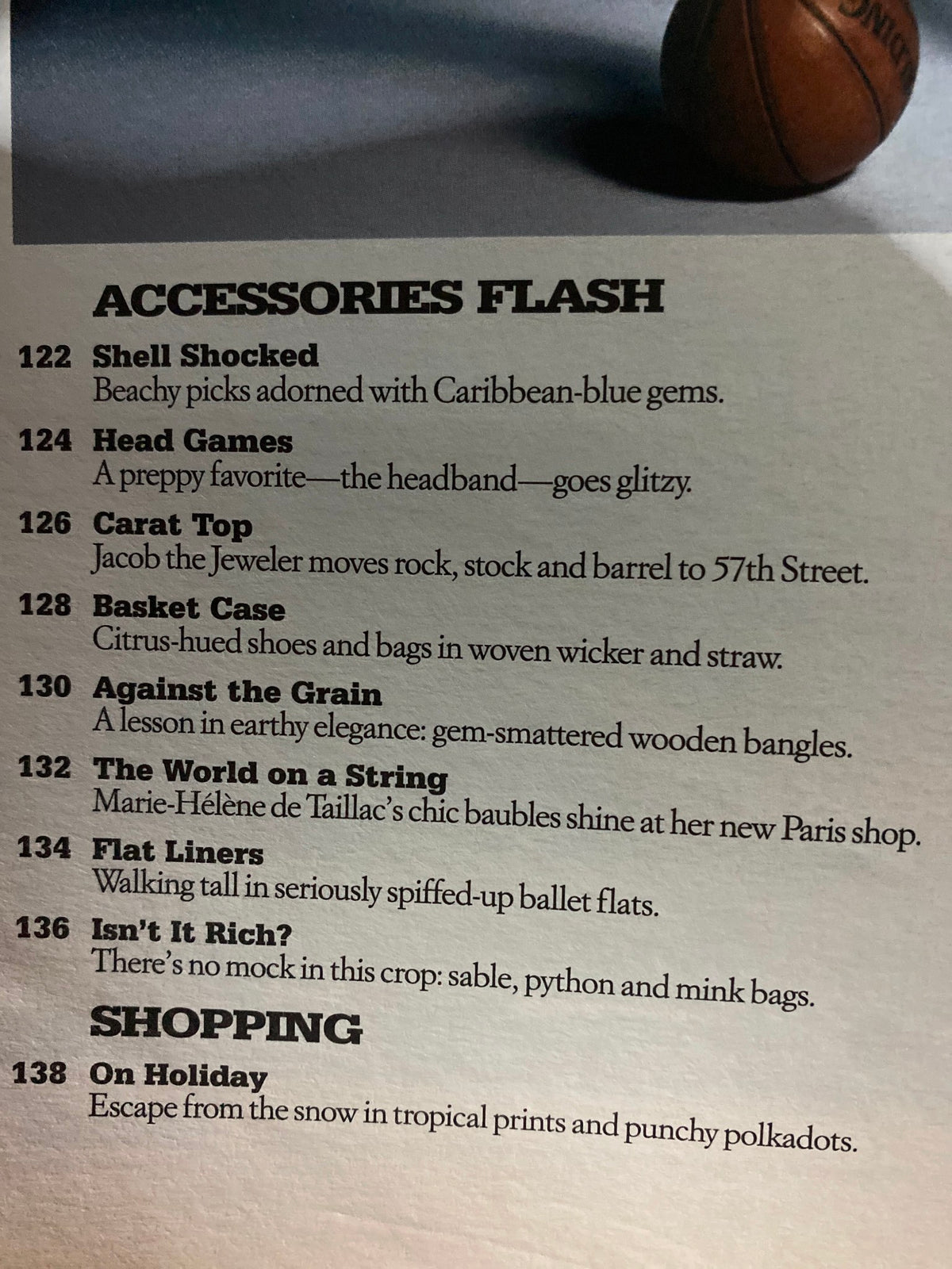 Page from W Magazine December 2004 displaying fashion accessories including colorful jewelry and a decorative basket, highlighting trends from the early 2000s.
