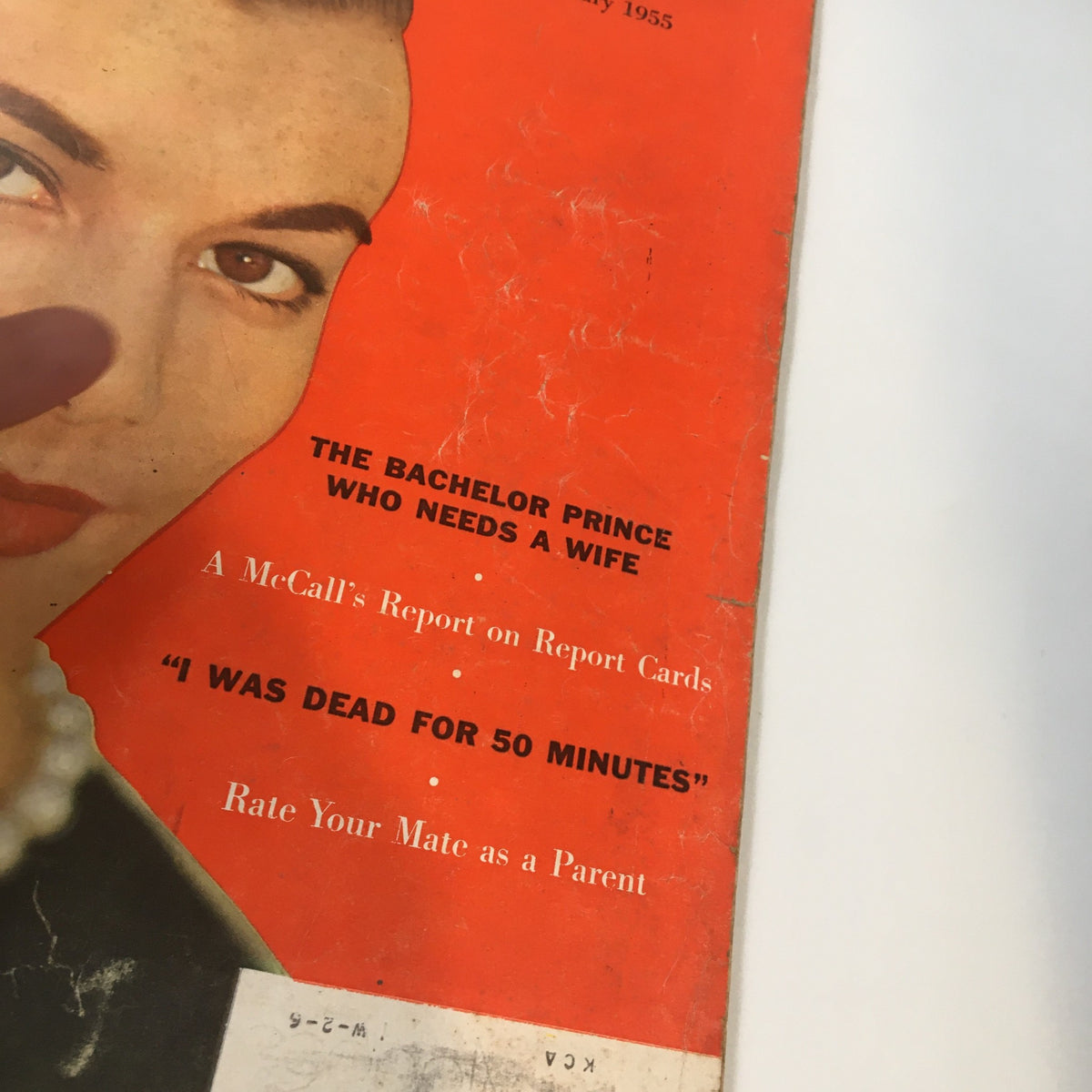 Close-up of the cover of VTG McCall's Magazine February 1955 with the phrase 'The Bachelor Prince Who Needs a Wife' visible, highlighting vintage design elements.