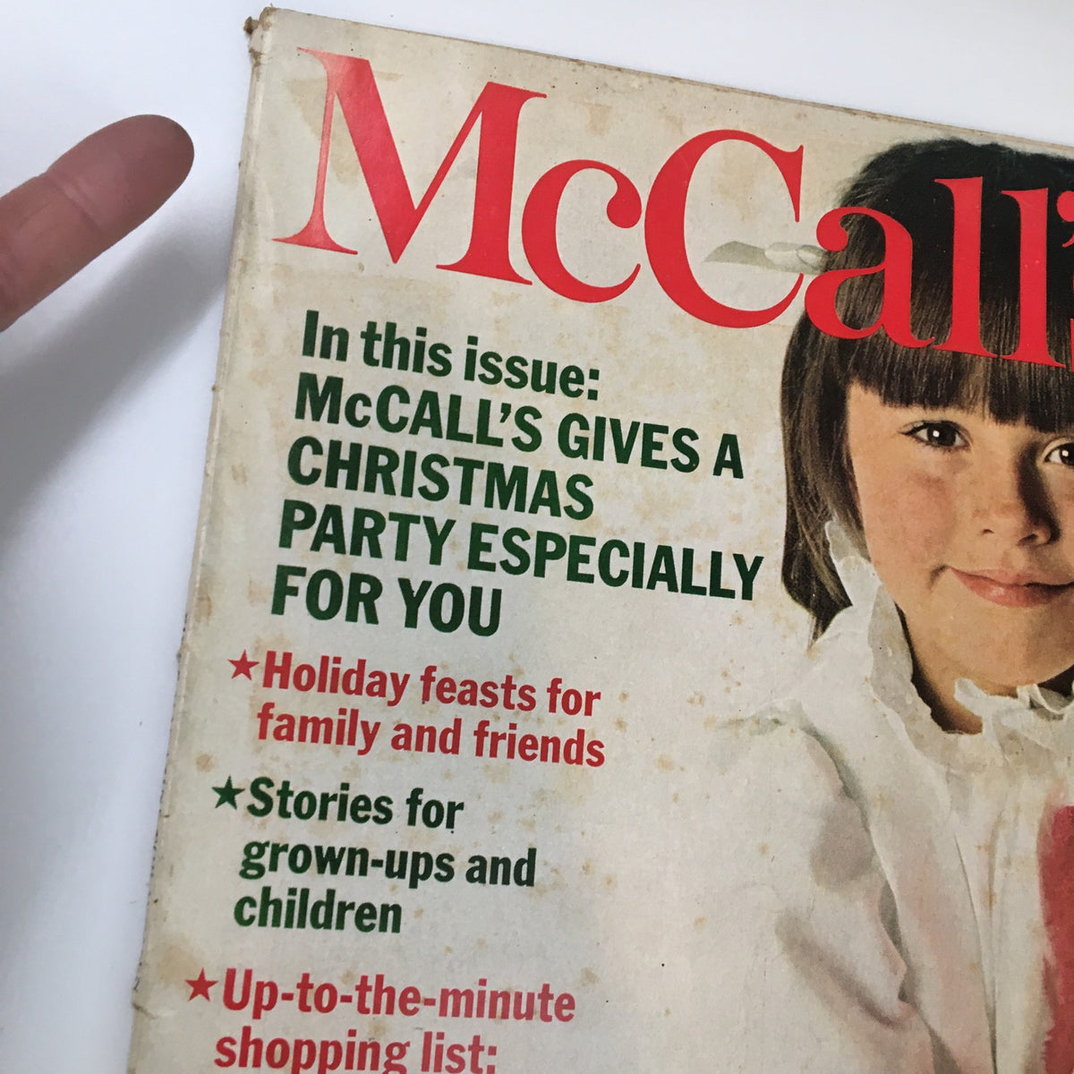 Alternative close-up view of the cover of VTG McCall's Magazine December 1968 highlighting festive content and holiday themes, featuring a child with a Christmas stocking.