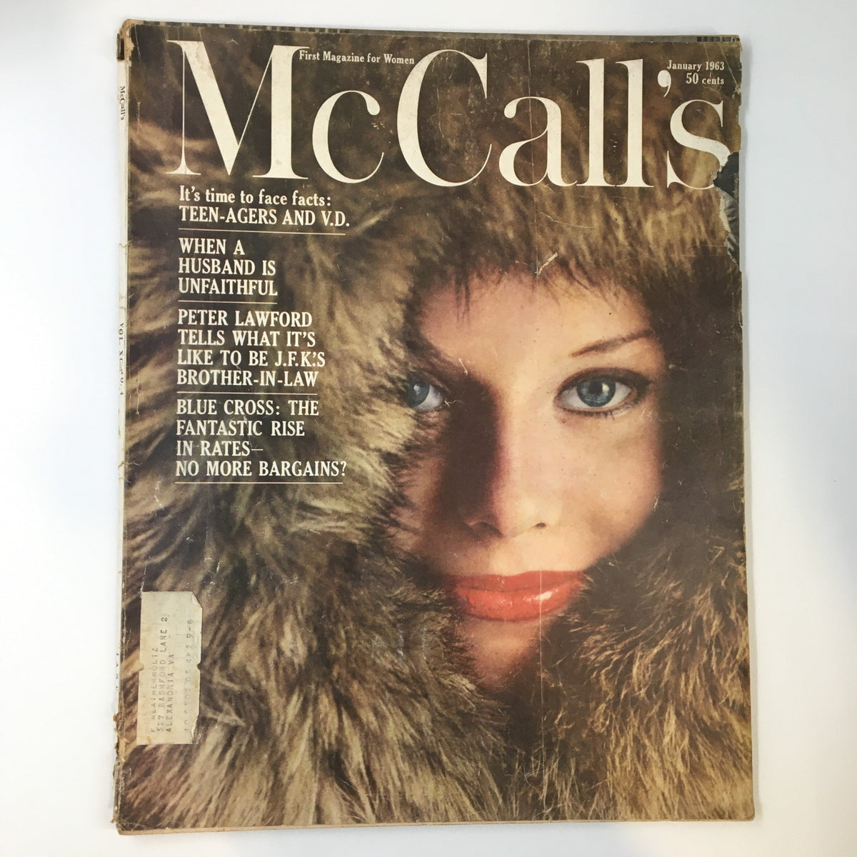 Cover of VTG McCall's Magazine January 1963 featuring a woman with blue eyes and red lips wearing a fur coat, highlighting Peter Lawford as JFK's brother-in-law.