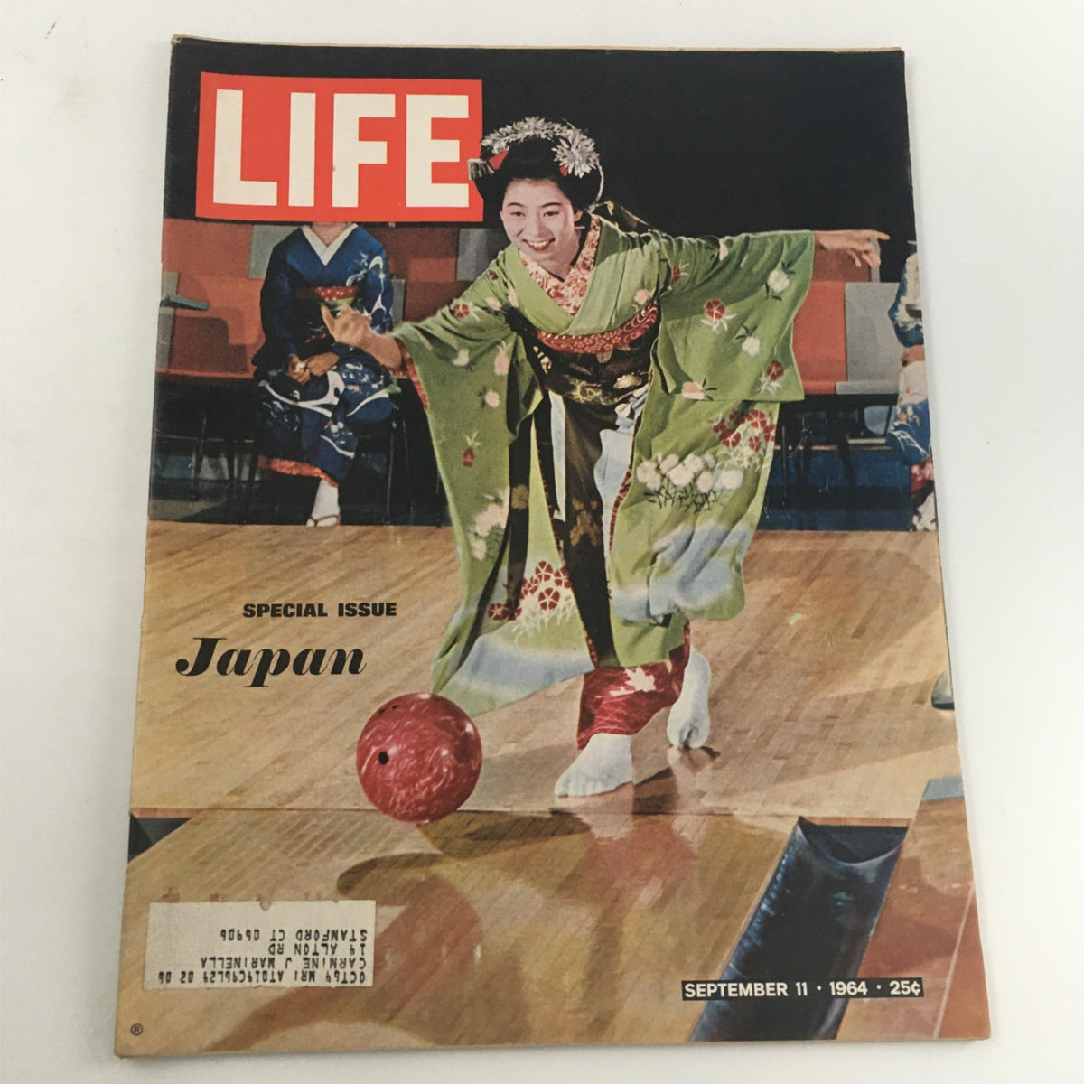 Cover of VTG Life Magazine September 11, 1964 Special Issue: Japan featuring a smiling woman in a traditional kimono bowling and colorful backdrops.