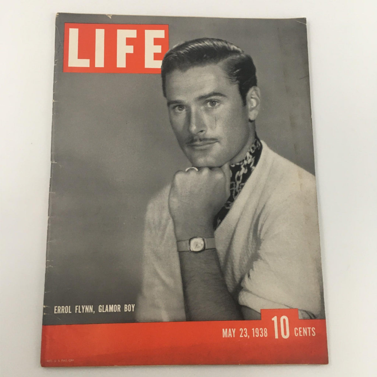 Cover of VTG Life Magazine from May 23, 1938 featuring Errol Flynn, Glamour Boy, showing a black-and-white portrait of Flynn in a sweater, posing thoughtfully.