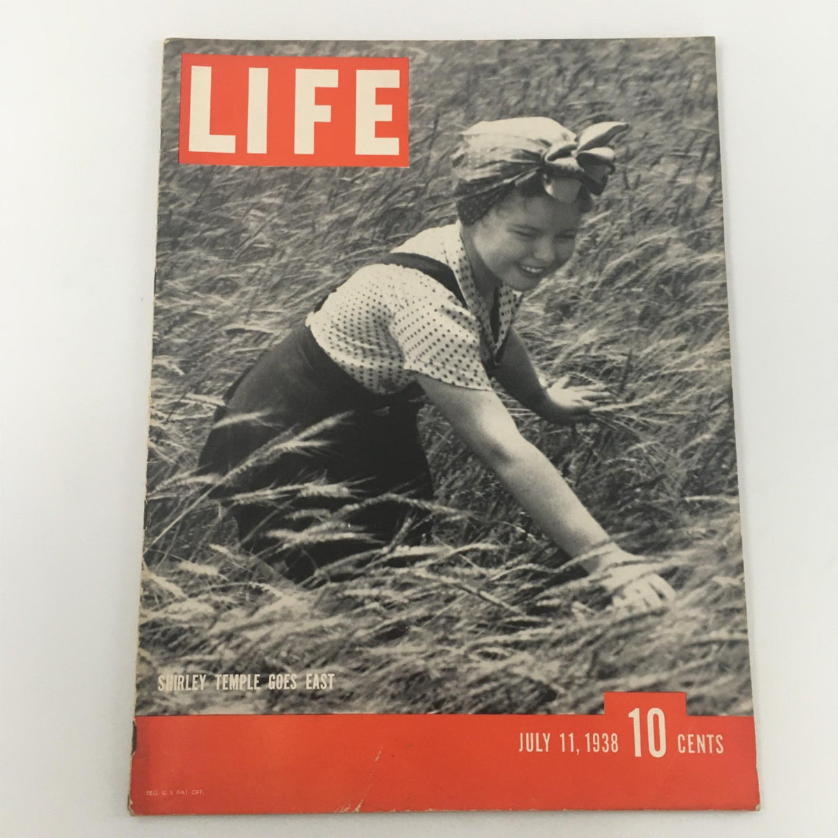 Vintage Life Magazine cover featuring Shirley Temple from July 11, 1938, showcasing her in a field, capturing the charm of the iconic child star and the nostalgic essence of the era.
