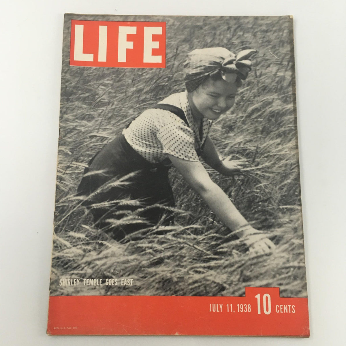 Cover of Life Magazine from July 11, 1938 featuring Shirley Temple, showcasing her in a field with the bold title 'LIFE', and the subtitle 'Shirley Temple Goes East'. The magazine is a vintage collectible highlighting American culture during the Great Depression.