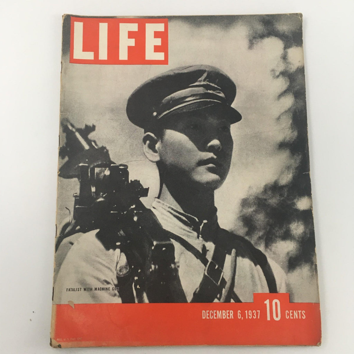 Cover of VTG Life Magazine December 6, 1937 featuring a man with a machine gun, titled 'Fatalist with Machine Gun', showcasing vintage print media from the late 1930s.