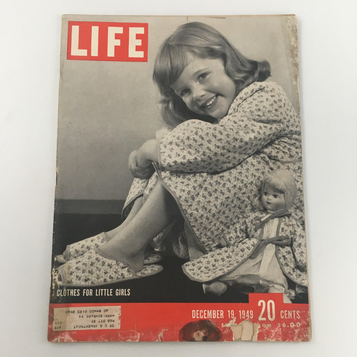 Cover of VTG Life Magazine December 19, 1949, featuring a smiling little girl in a floral dress with a doll, showcasing styles for little girls in a post-war fashion context.