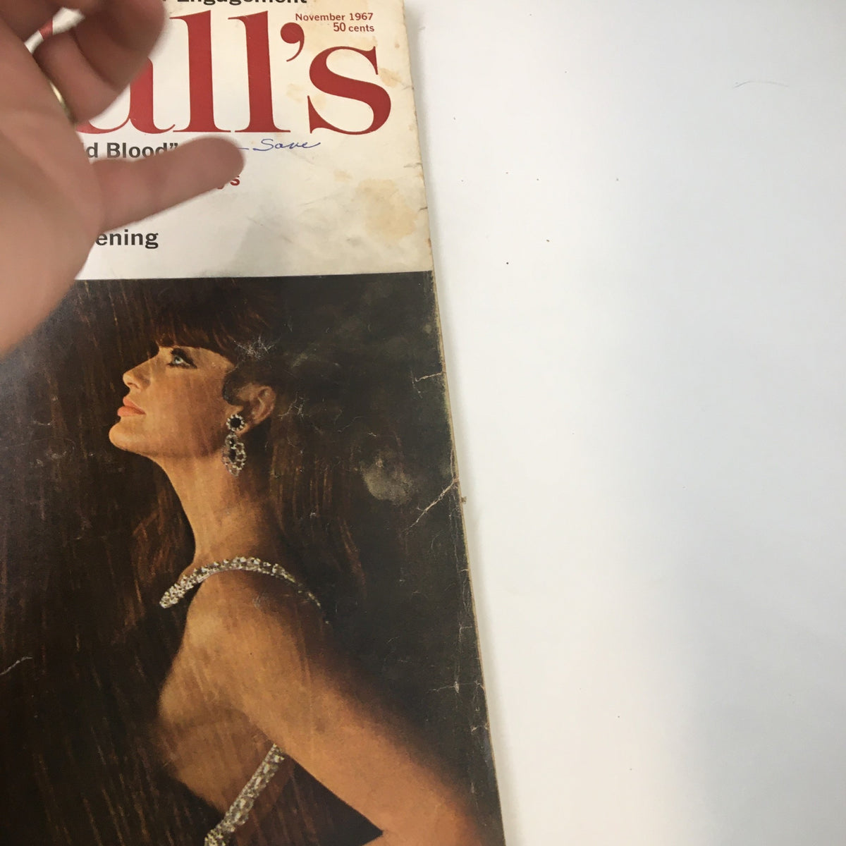 Detail view of the vintage November 1967 McCall's Magazine cover highlighting Truman Capote's first story 'In Cold Blood', with focus on the model's profile and fashion jewelry.