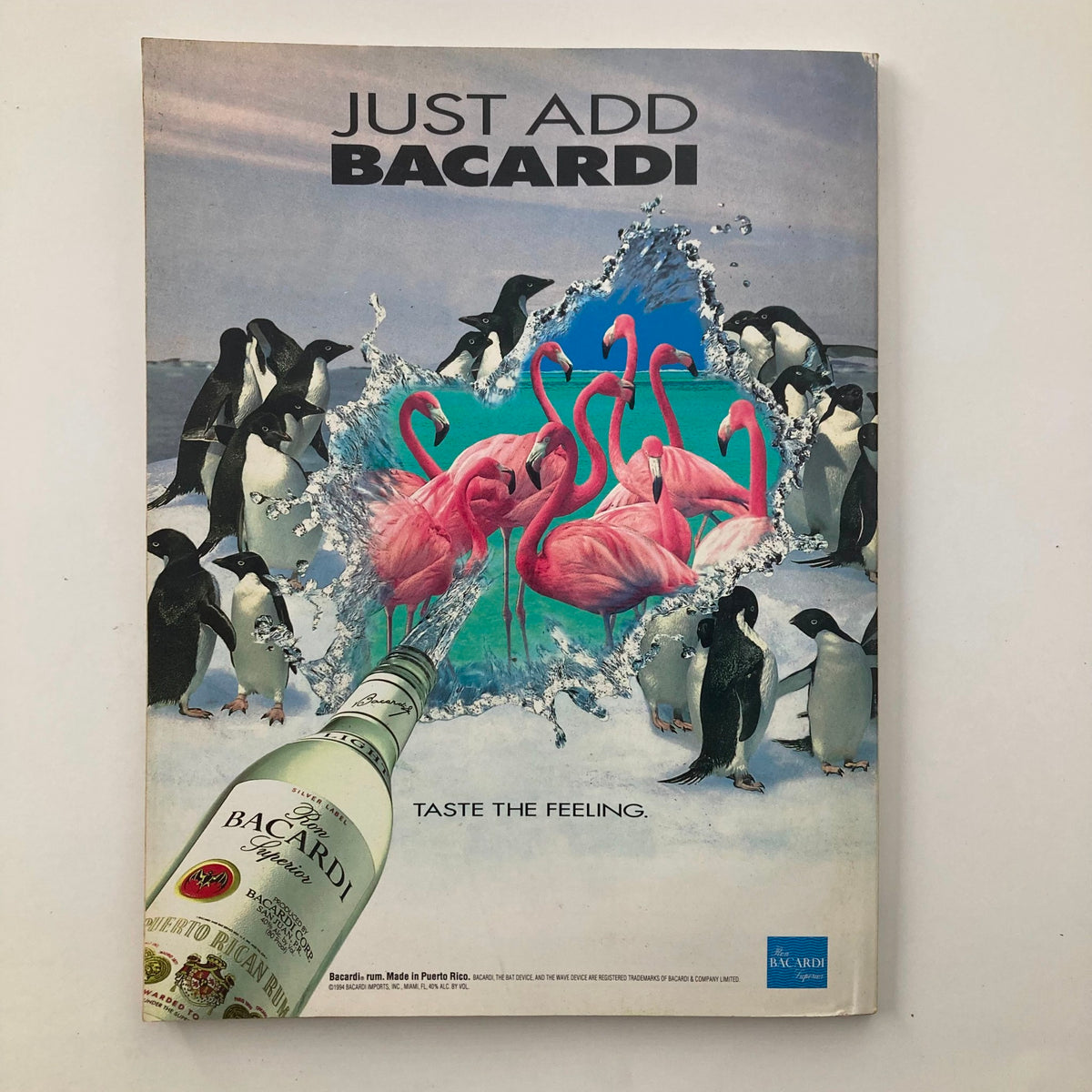 Just Add Bacardi advertisement featuring pink flamingos and penguins, promoting the brand with the slogan 'Taste the Feeling'.