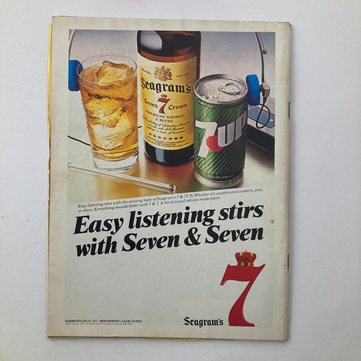 Back cover of Vintage National Lampoon Sports Magazine July 1982 showcasing an advertisement for Seagram's 7 Crown whiskey and 7UP featuring a glass and bottle.