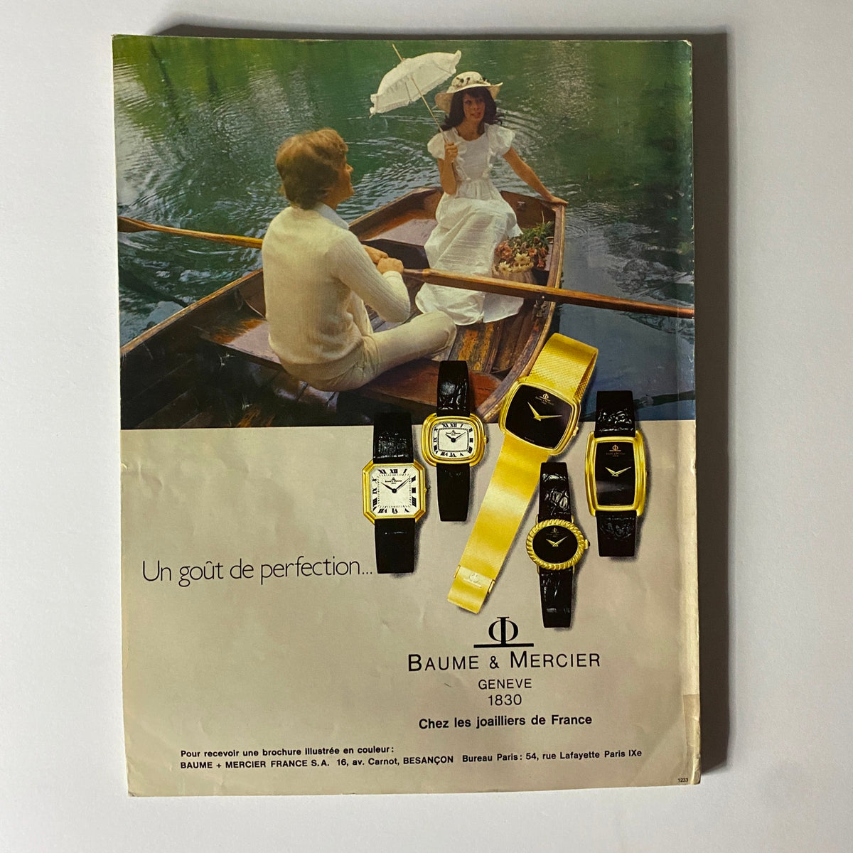 Vintage advertisement for Baume & Mercier watches from Vogue Paris Magazine August 1976, featuring a romantic boat scene and showcasing elegant timepieces, embodying the fashion of the 1970s.