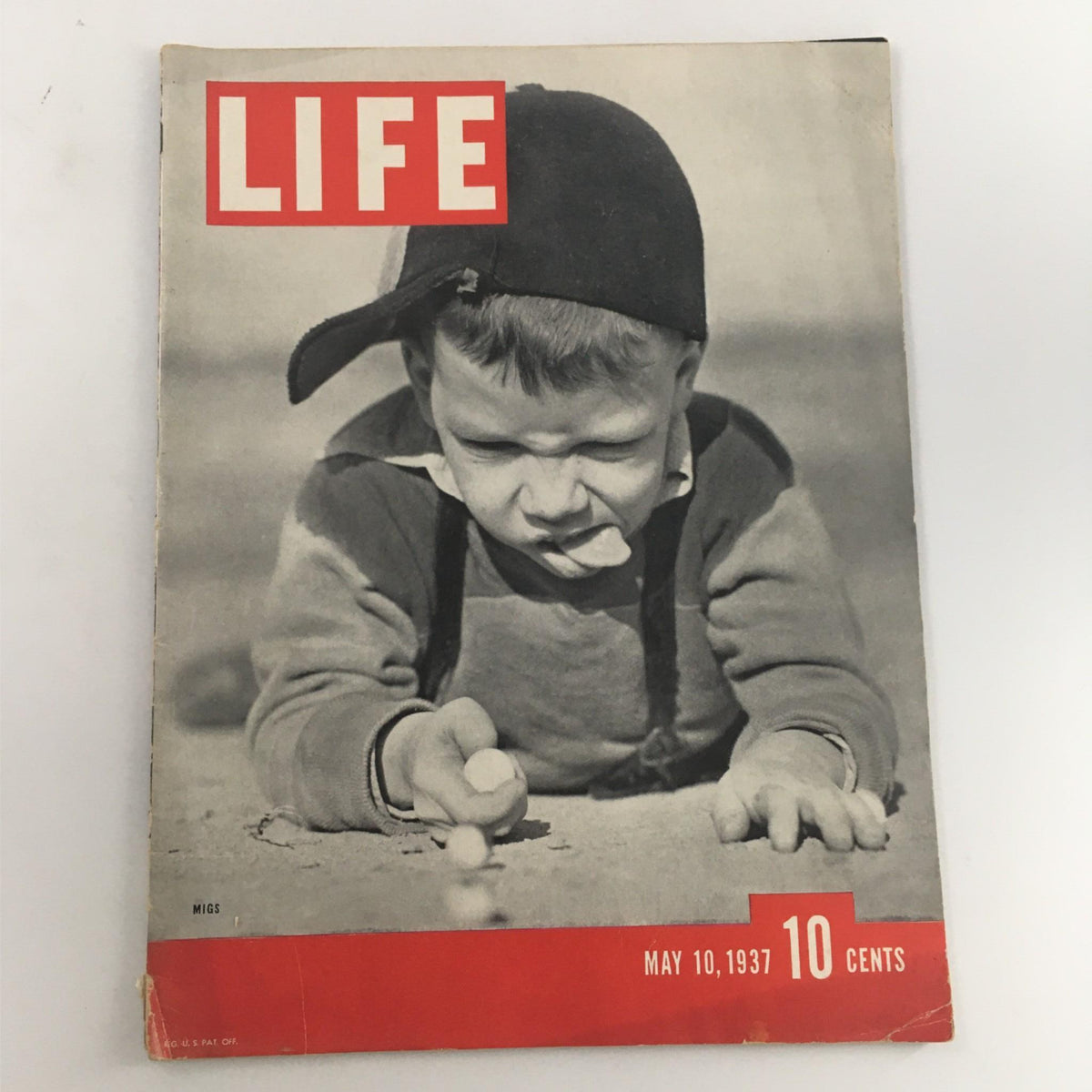 Cover of Life Magazine from May 10, 1937, featuring a boy playing marbles, showcasing childhood in the 1930s.