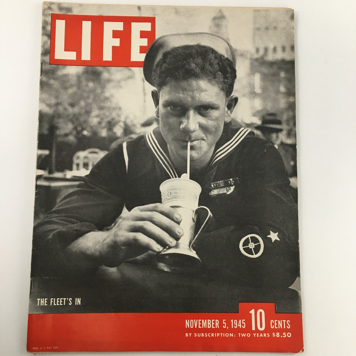Cover of Life Magazine from November 5, 1945, titled 'The Fleet's In', featuring a Navy sailor enjoying a drink, symbolizing post-World War II sentiment.