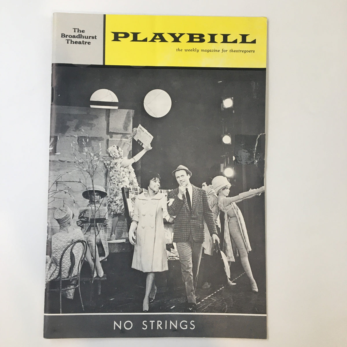 1963 Playbill from the Broadhurst Theatre featuring 'No Strings', showcasing a theatrical performance scene with actors in costume.