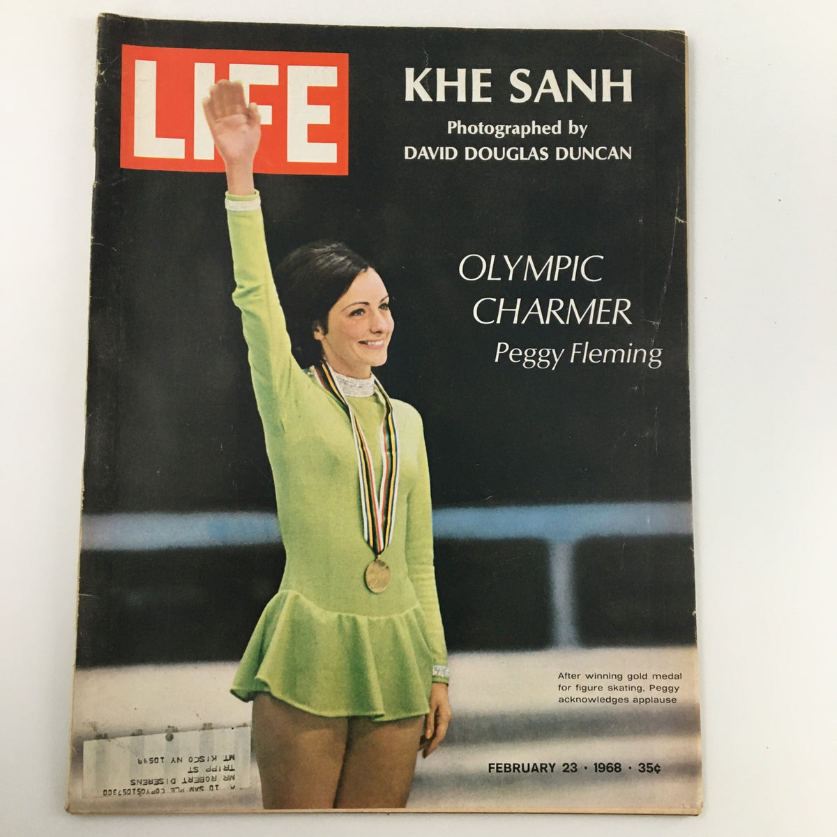 Life Magazine cover from February 23, 1968 featuring the Khe Sanh battle story and Olympic champion Peggy Fleming. The cover shows Peggy Fleming in a green skating outfit, smiling and holding a gold medal, celebrating her achievements.