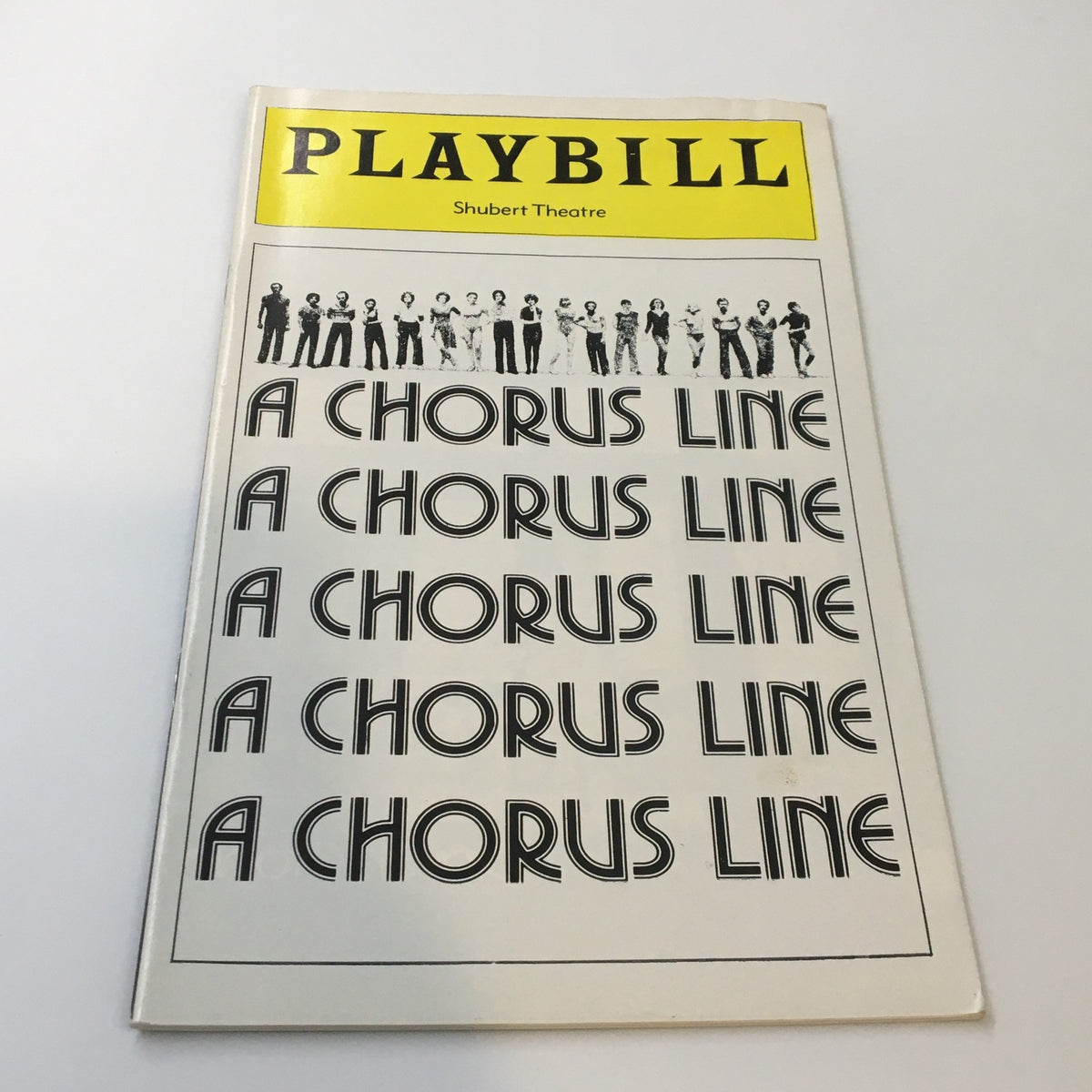 1977 Playbill from the Shubert Theatre showcasing the iconic musical 'A Chorus Line,' featuring bold typography and a minimalist design.