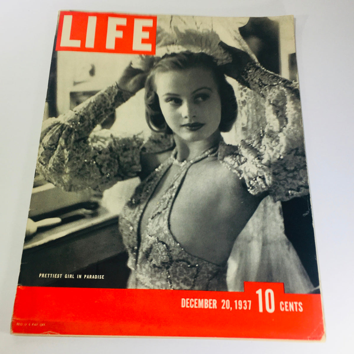 Vintage Life Magazine cover from December 20, 1937, featuring the title 'Prettiest Girl In Paradise'. The cover showcases an elegant model wearing a sparkling gown, reflecting the style of the era.
