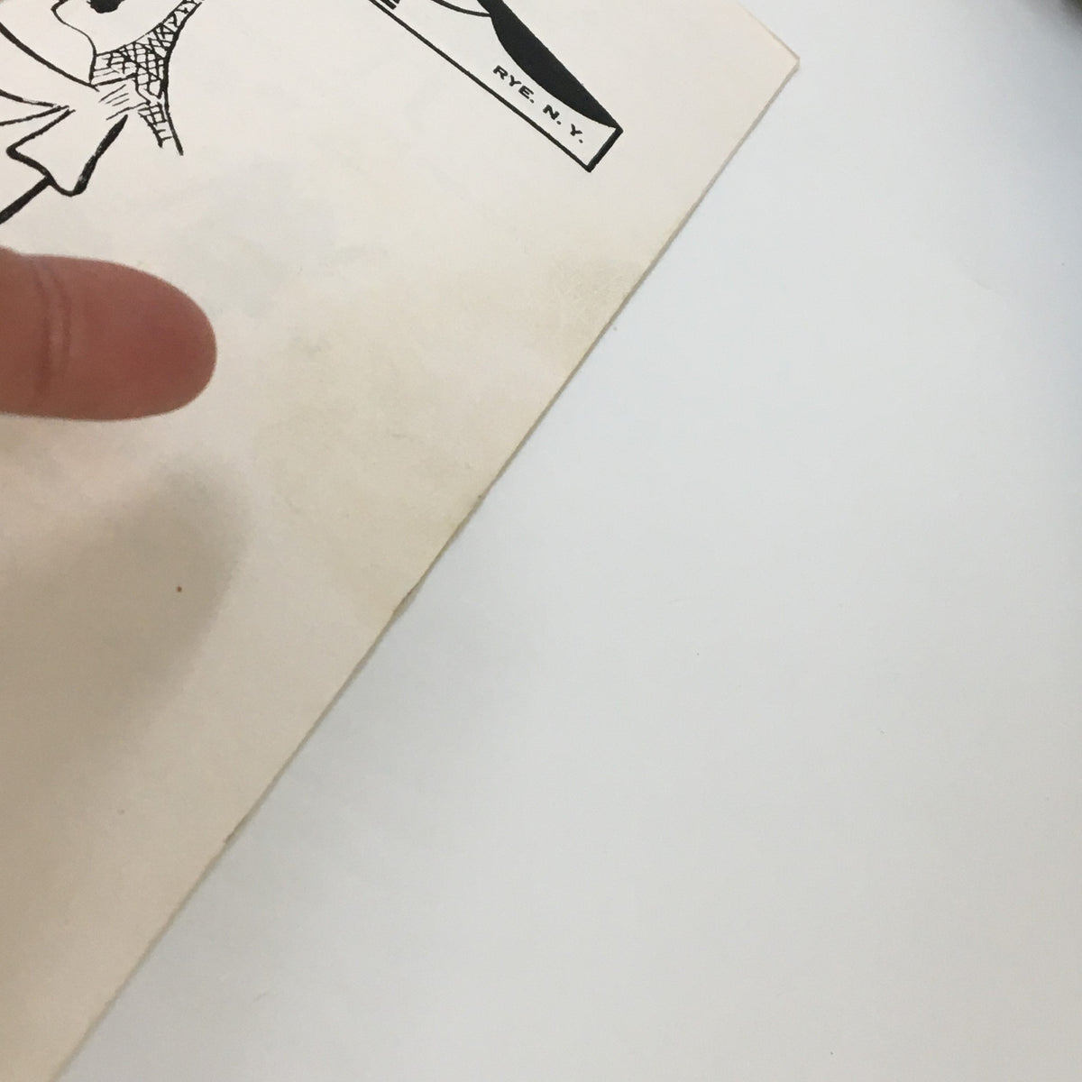 Close-up of the cover of 1957 Phil Moloney's Music Theatre Can-Can by Bertram Yarborough, highlighting minor wear and a finger pointing at the edge.