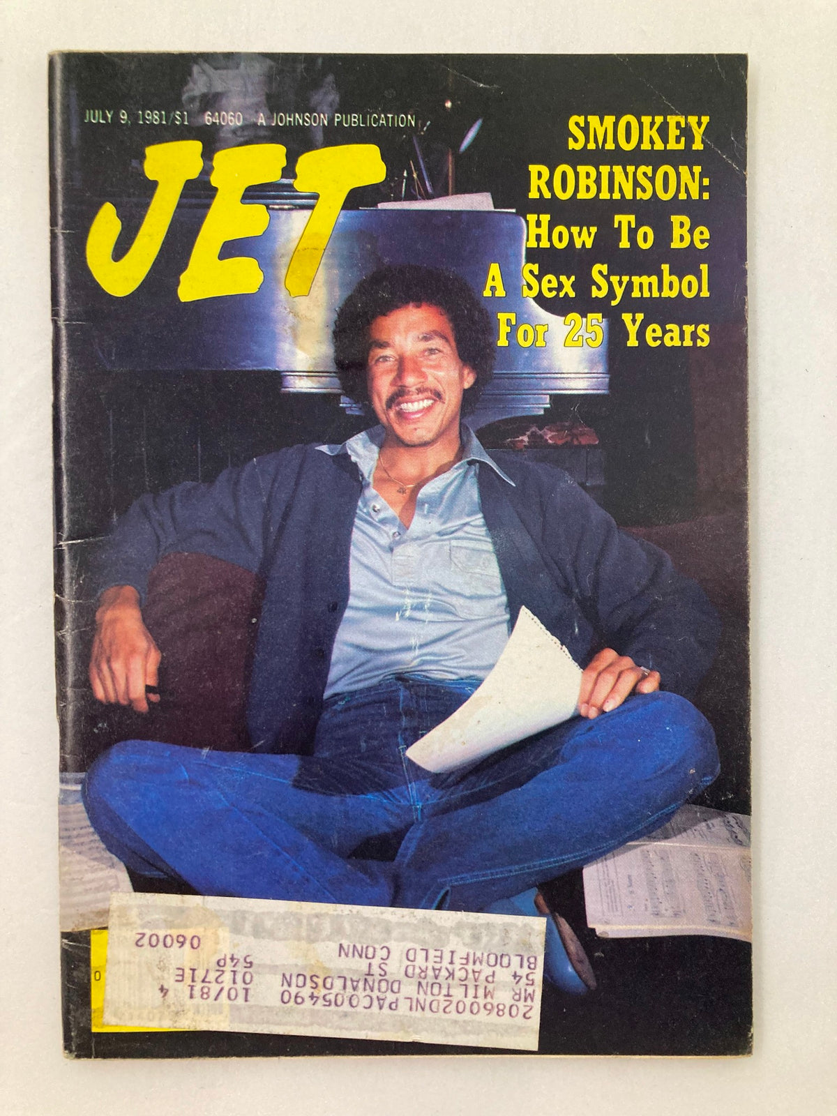 Cover of VTG Jet Magazine July 9, 1981, Vol 60 #17 featuring Smokey Robinson, entitled "How To Be A Sex Symbol For 25 Years." The cover showcases Smokey Robinson smiling, sitting cross-legged with papers around him, highlighting the cultural significance of this vintage magazine.