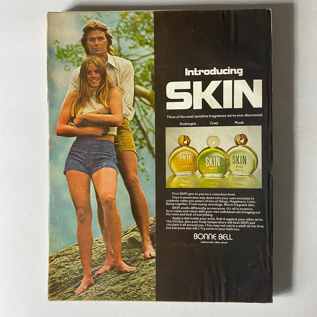 Back cover of Vogue Magazine November 1973 featuring an introduction to SKIN fragrances by Bonne Bell, showcasing a stylish couple against a natural backdrop.