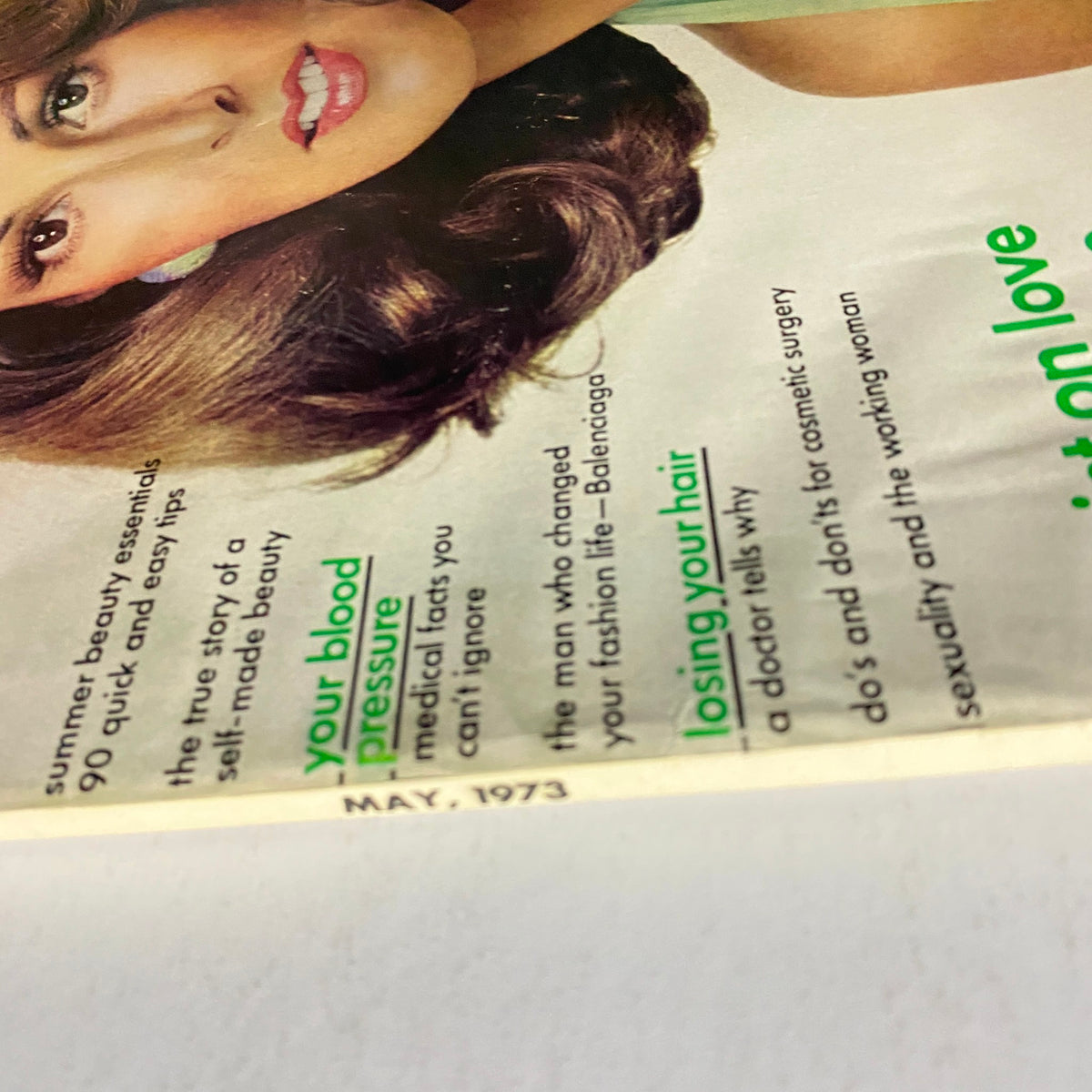 Close-up of Raquel Welch on the May 1973 cover of Vogue Magazine, showcasing 1970s beauty trends and topics.