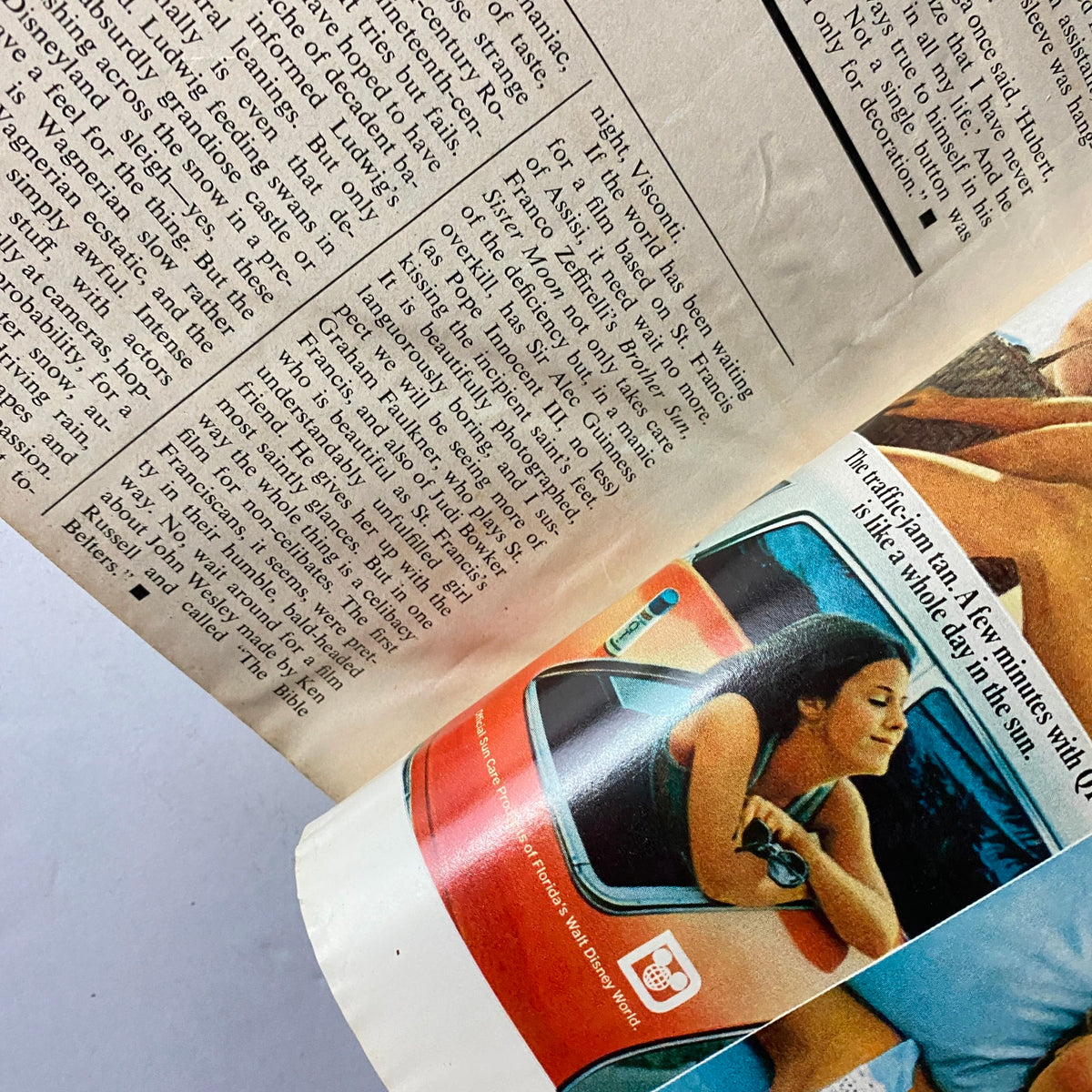 Interior view of a May 1973 Vogue Magazine featuring an advertisement with a woman enjoying a drive, showcasing the vibrant lifestyle and fashion trends of the early 1970s. Vogue Magazine May 1973 Raquel Welch Cover No Label.
