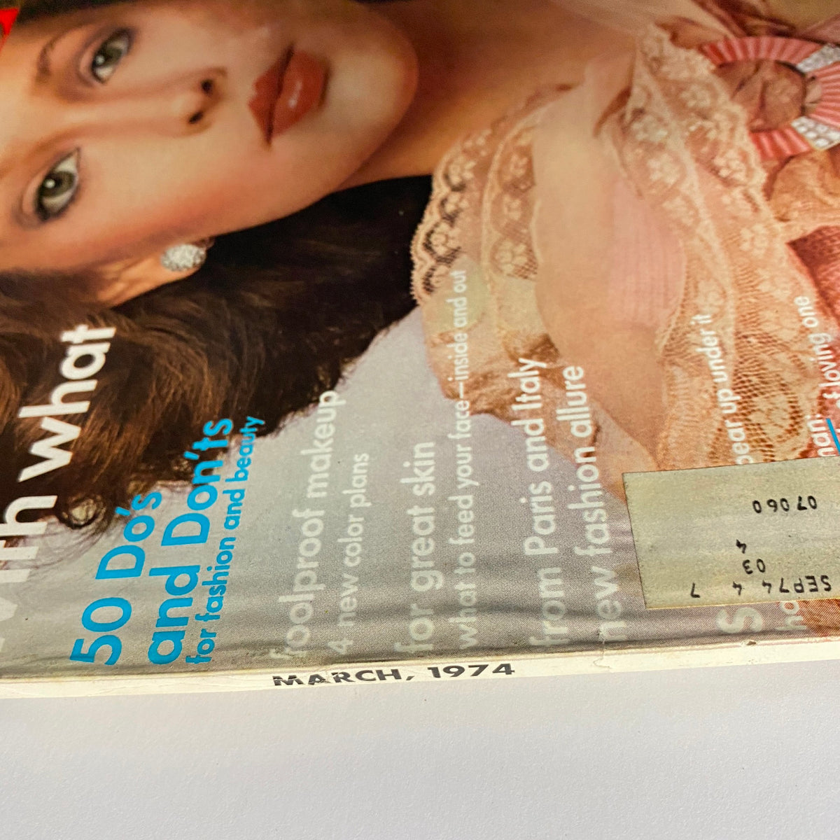 Detailed shot of the March 1974 Vogue Magazine cover, highlighting the main title and features related to fashion and beauty.