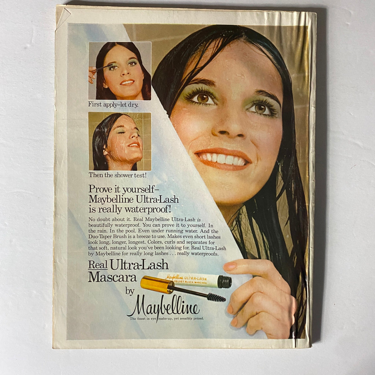 Back cover of Vogue Magazine August 1974 featuring an advertisement for Maybelline Ultra-Lash mascara, showcasing beauty product features and a smiling model.