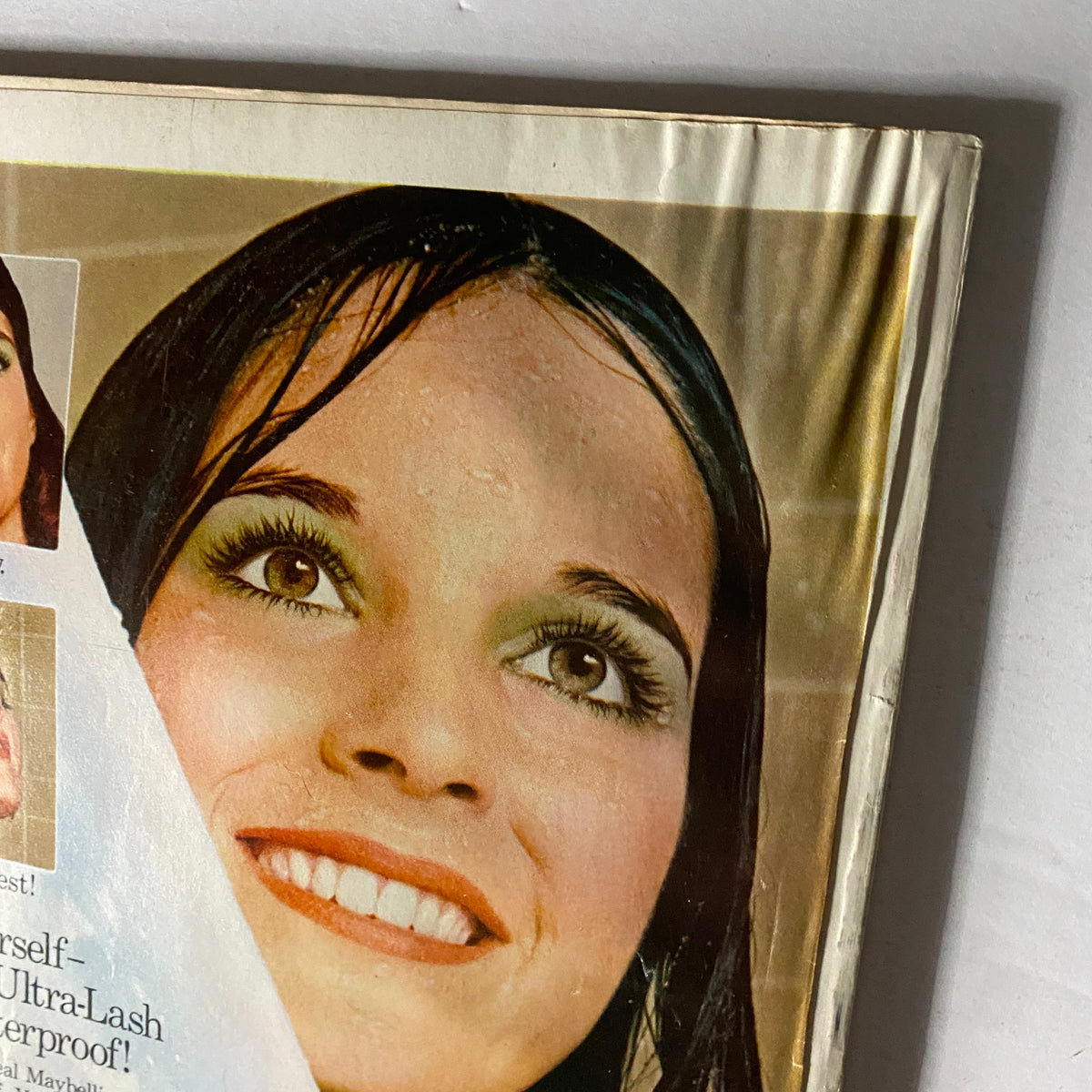 Cover image of Vogue Magazine, August 1974 featuring a model with dramatic makeup and a radiant smile, showcasing the vibrant beauty trends of the 1970s.