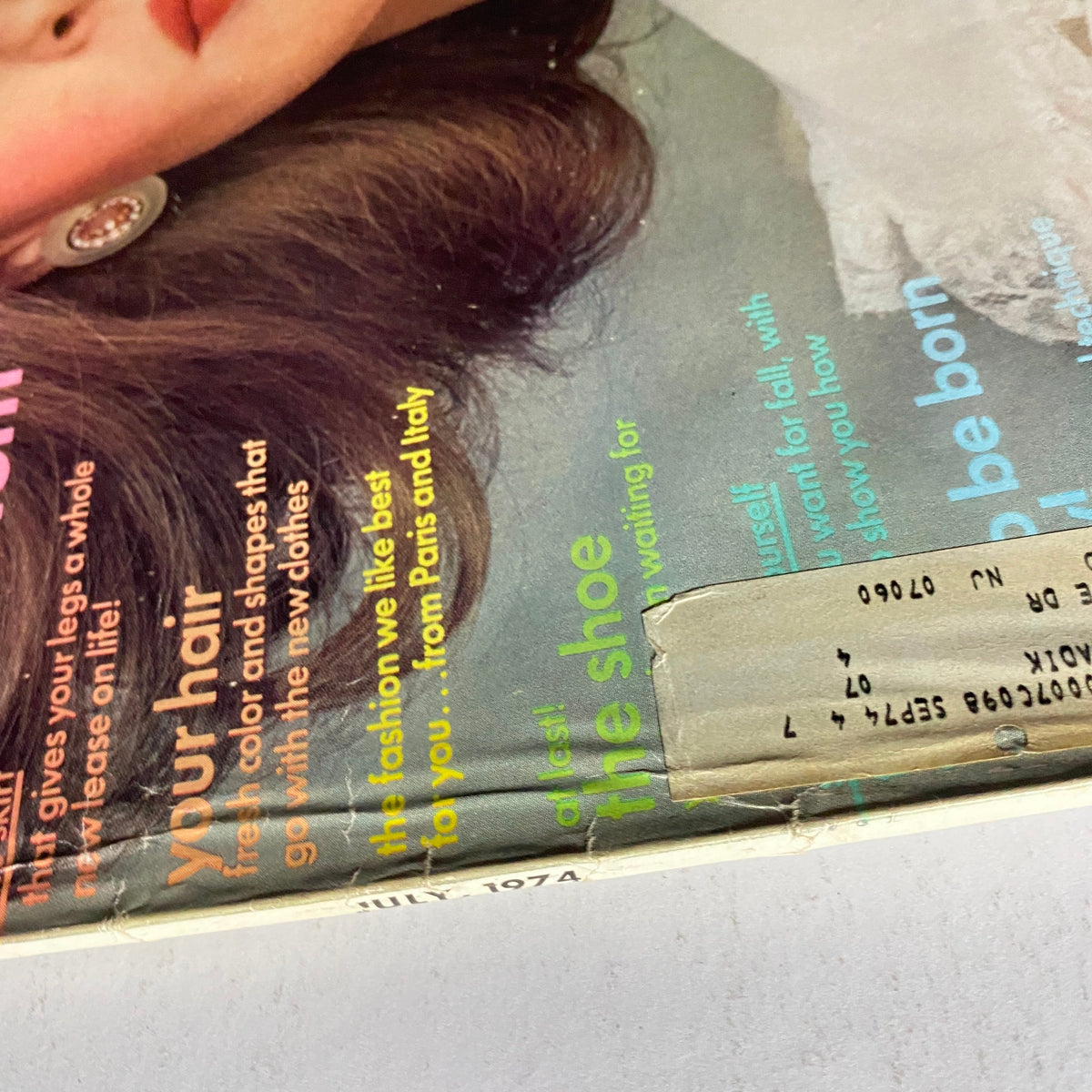 Close-up of Vogue Magazine July 1974 Rene Russo Cover - Detailed view of the vintage magazine cover featuring model Rene Russo, showcasing the striking makeup and hair styles popular in the 1970s.