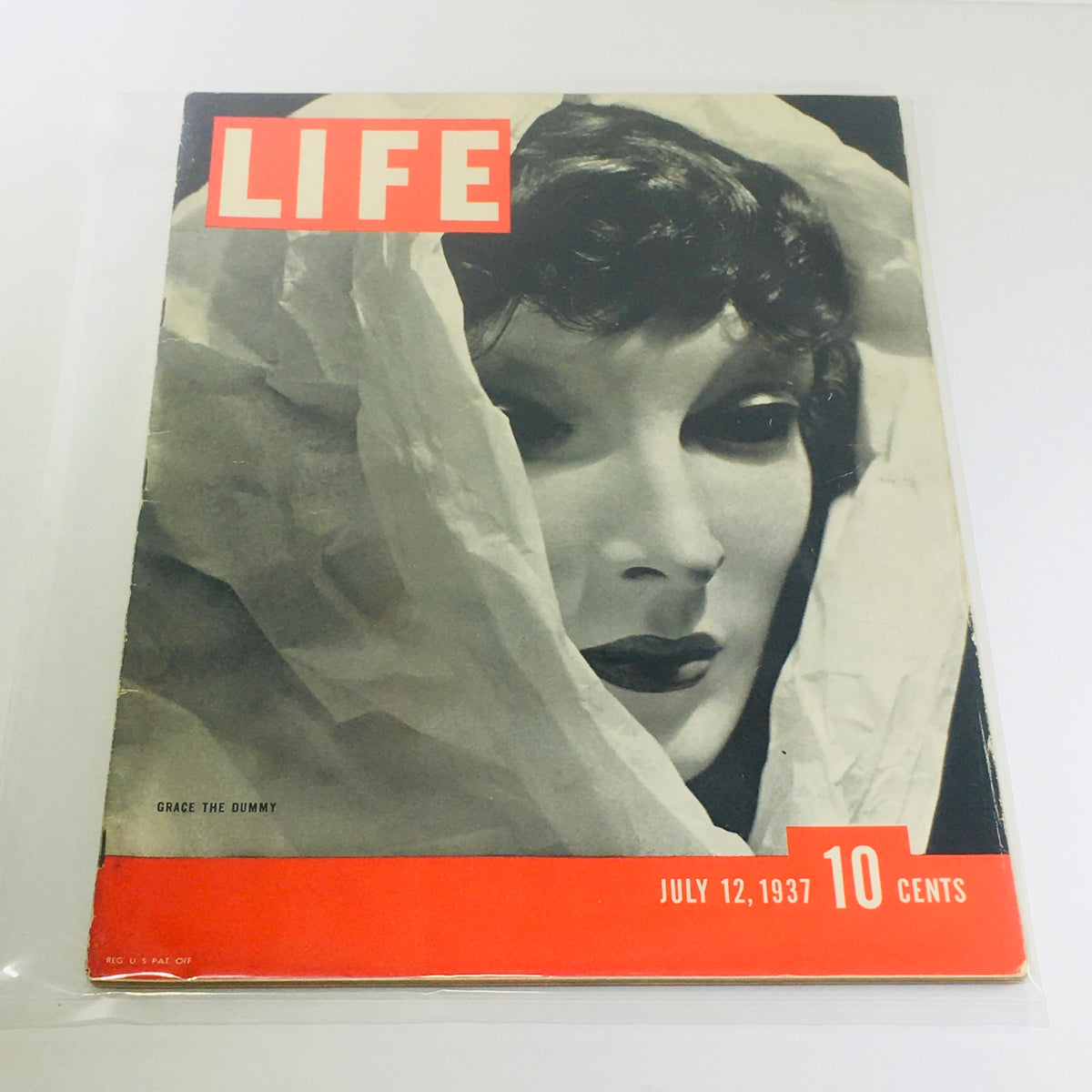 Vintage Life Magazine cover from July 12, 1937, featuring Grace The Dummy, showcasing a nostalgic black and white portrait style with bold red accents, perfect for collectors of historical magazines.