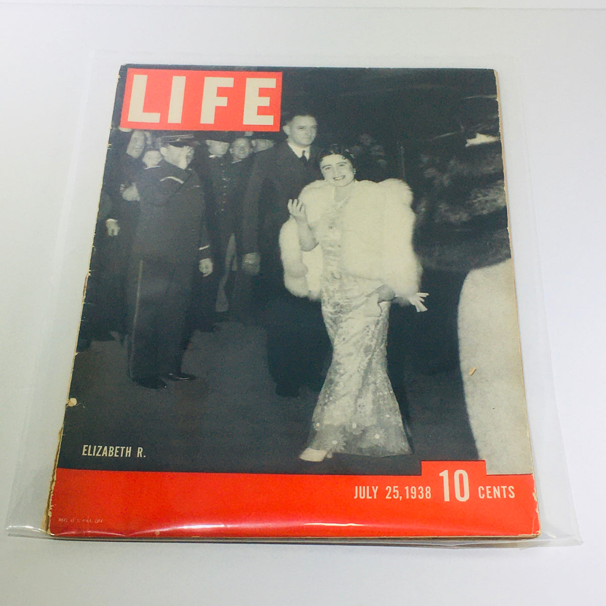 Vintage Life Magazine cover from July 25, 1938 featuring Elizabeth R., showcasing a black and white photo of her in a white fur wrap, amidst a crowd, with prominent red and white lettering.