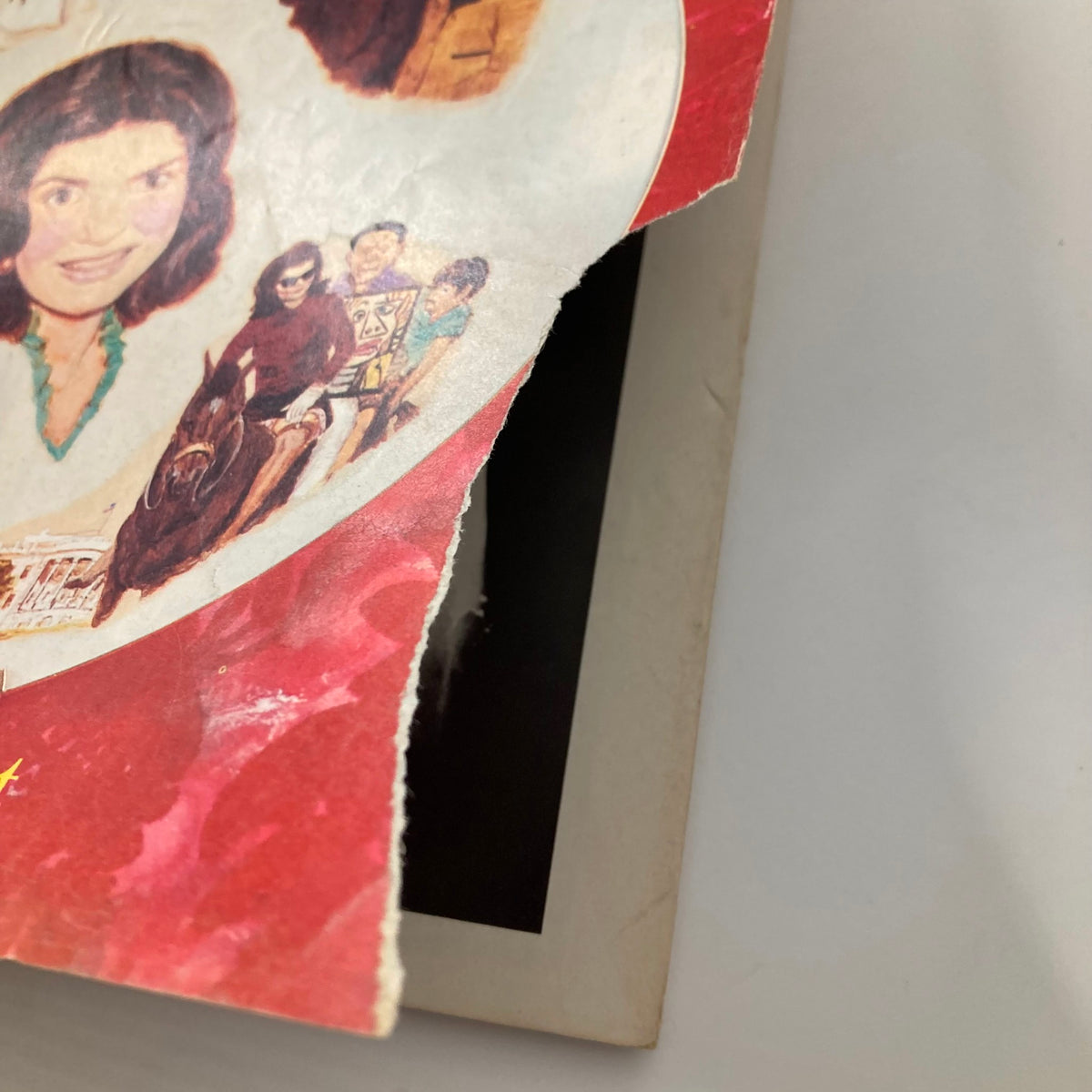 Cover detail of Vintage National Lampoon Magazine March 1975 featuring Jackie Kennedy, showcasing wear and creases typical of vintage collectibles.