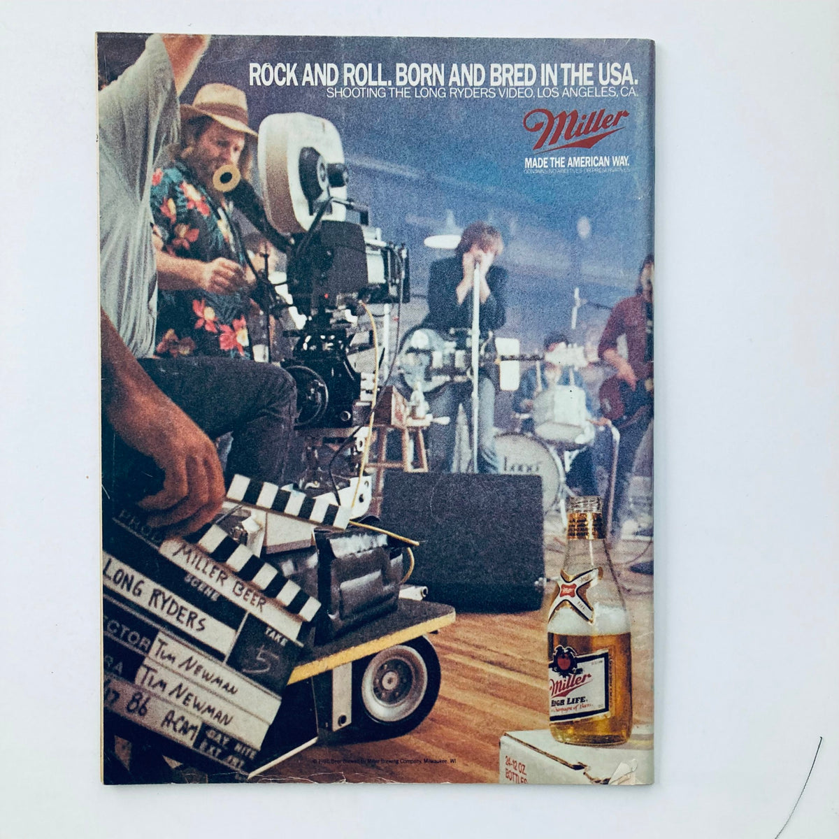 Vintage National Lampoon Magazine September 1986 cover featuring a behind-the-scenes look at 'Rock and Roll, Born and Bred in the USA' with a film camera setup, including crew and musical instruments.
