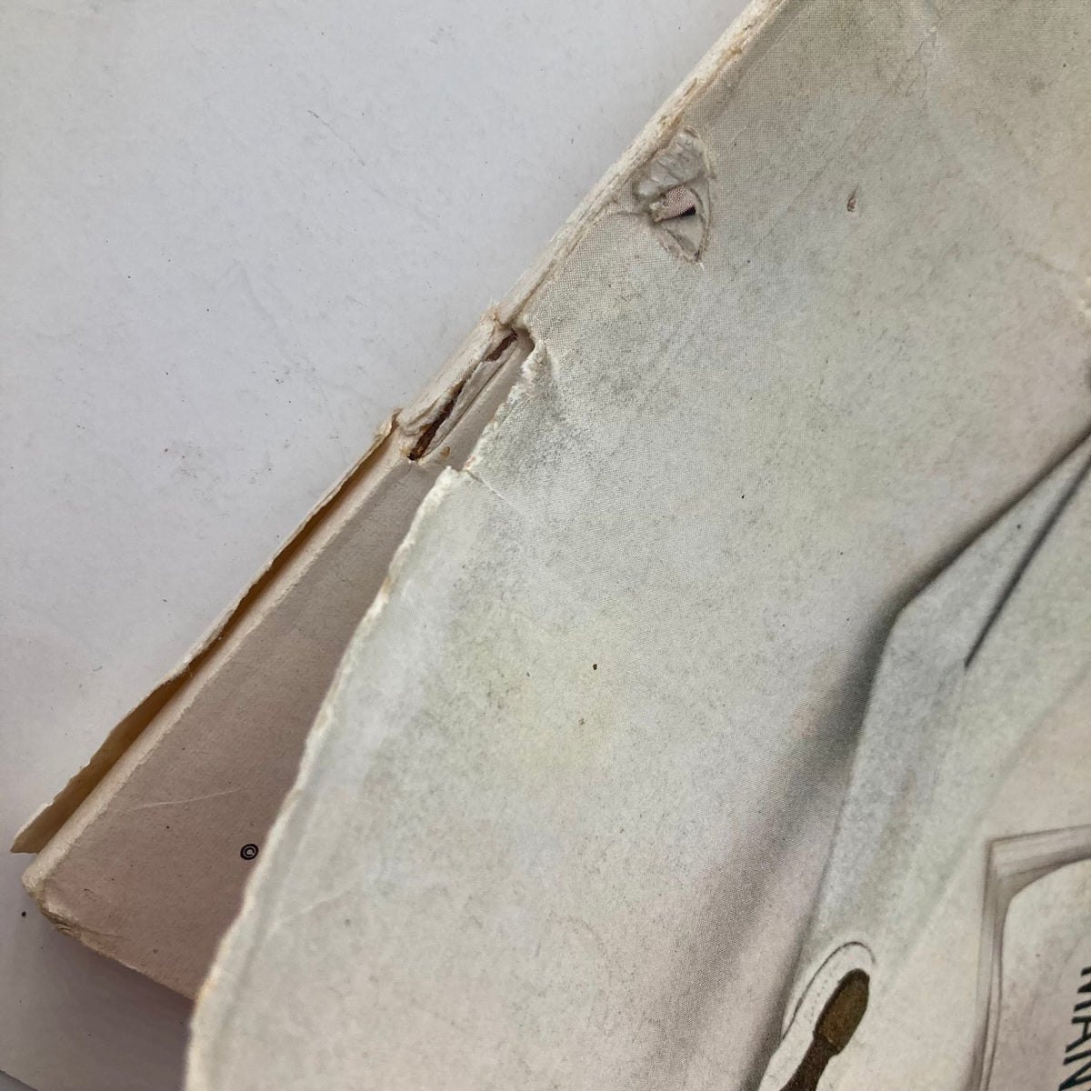 Close-up view of the spine and edge of the vintage Playboy magazine June 1963 featuring covergirl Jayne Mansfield. Visible wear and tear indicate the magazine's age.