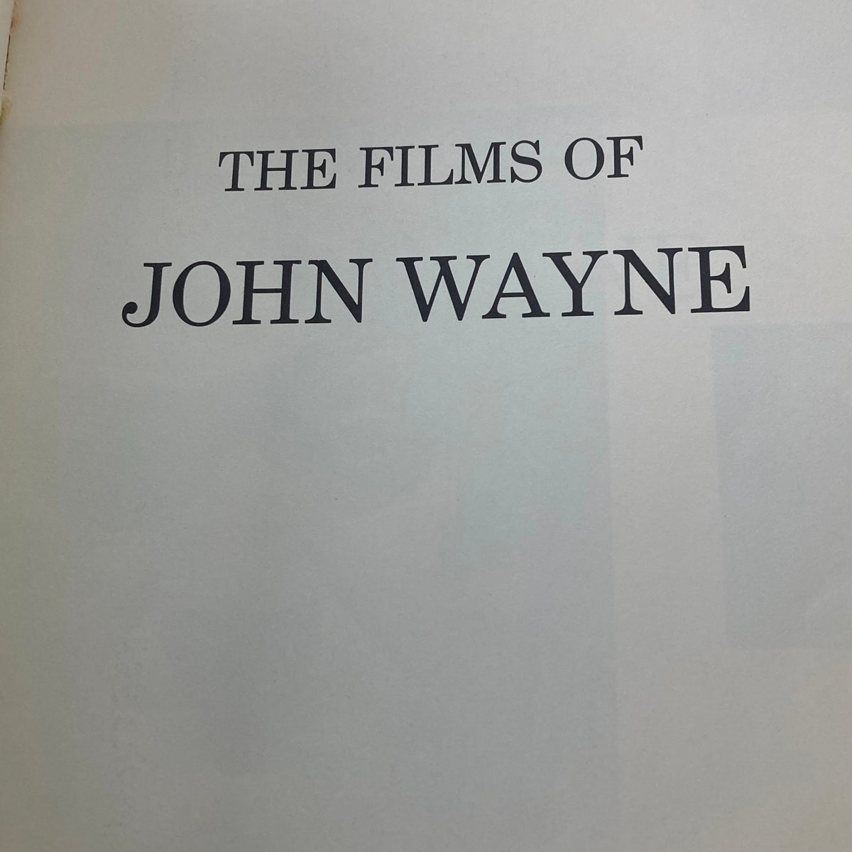 Page from VTG 1976 The Films of John Wayne by Mark Ricci, Boris & Steve Zmijewsky, showcasing the title 'The Films of John Wayne' in bold.