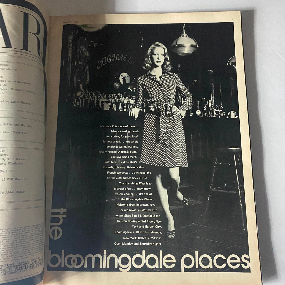 Black and white photo of a model in Harper's Bazaar Magazine February 1973 displaying a stylish dress while promoting Michael's Pub in New York, showcasing 1970s fashion.