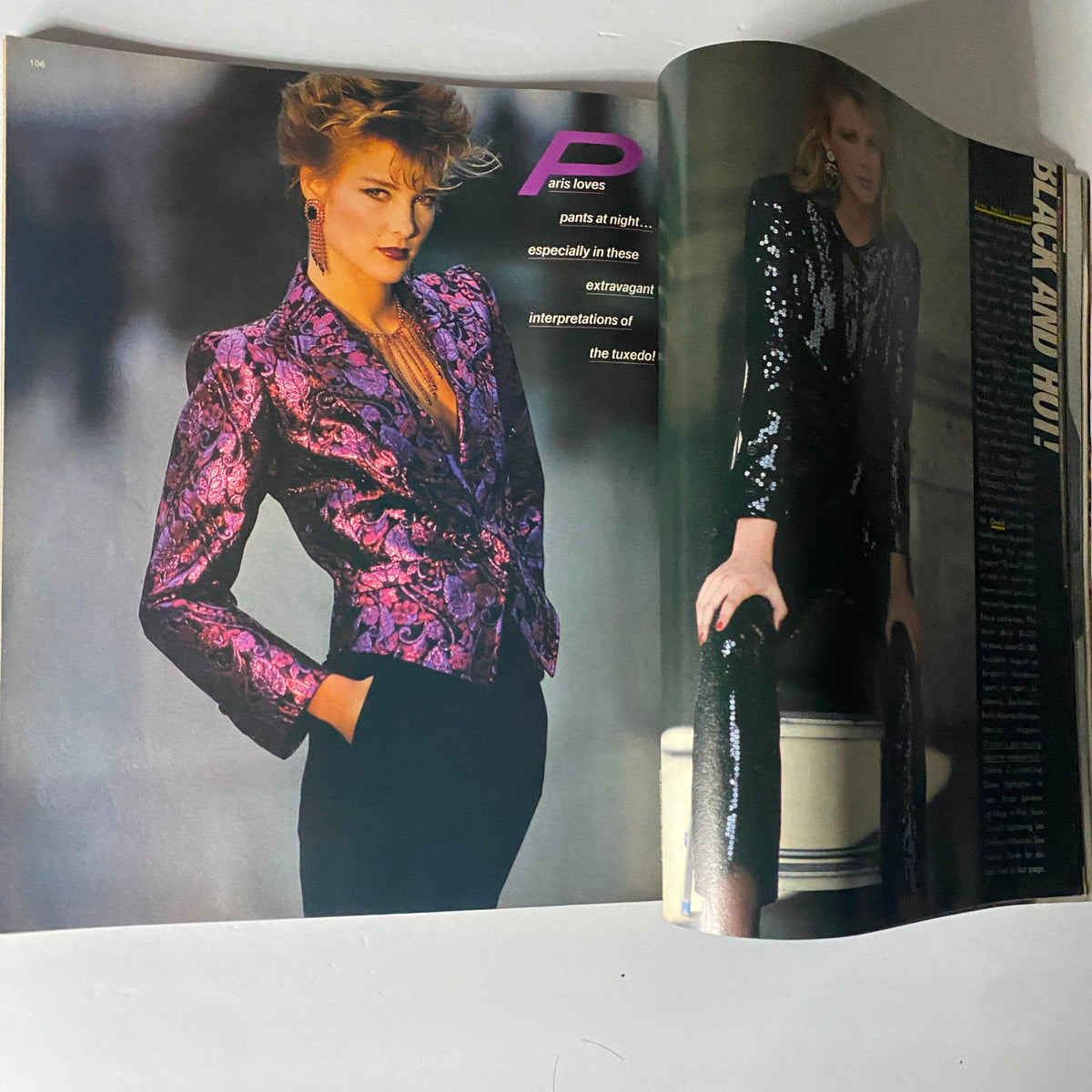 Harper's Bazaar Magazine July 1982, featuring a model in a luxurious purple tuxedo jacket and black pants, highlighting extravagant evening wear of the era.