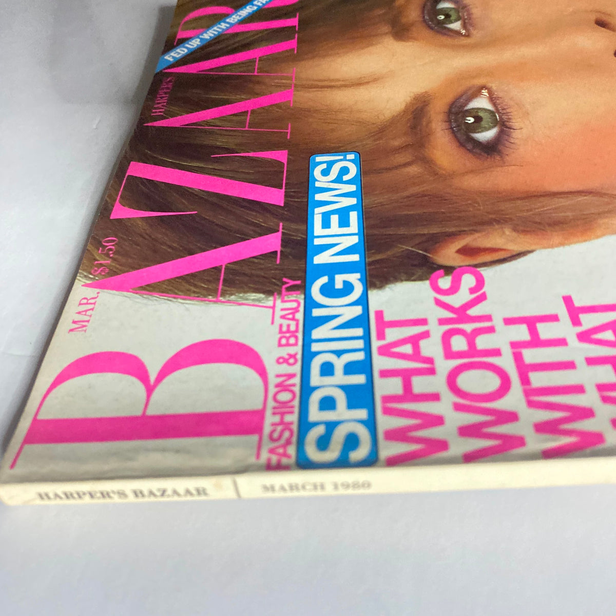 Harper's Bazaar Magazine March 1980 cover featuring striking pink typography and a model's captivating gaze, showcasing the fashion and beauty of the era.