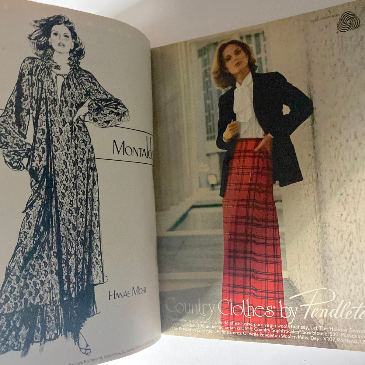Inside view of Harper's Bazaar Magazine October 1977, featuring fashion advertising for Hanae Mori with a model in a stylish, flowing robe and another model in a tailored blazer and plaid skirt.