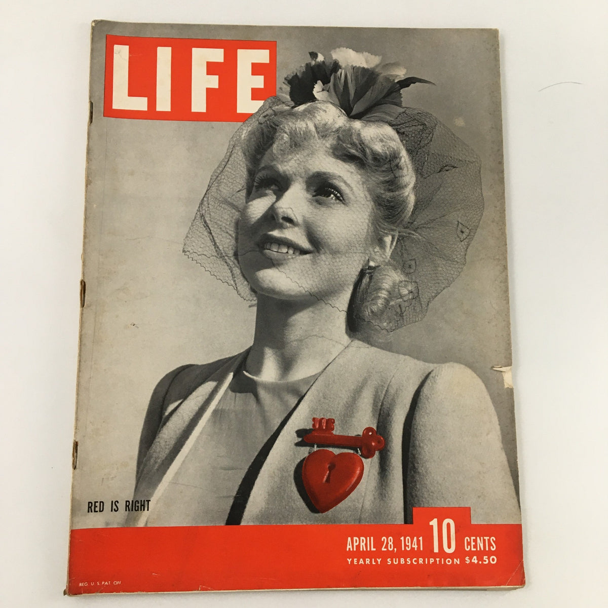Cover of VTG Life Magazine from April 28, 1941, featuring the title 'Red is Right.' The magazine showcases a smiling woman wearing a decorative hat and a heart-shaped pin, indicative of the 1940s style.