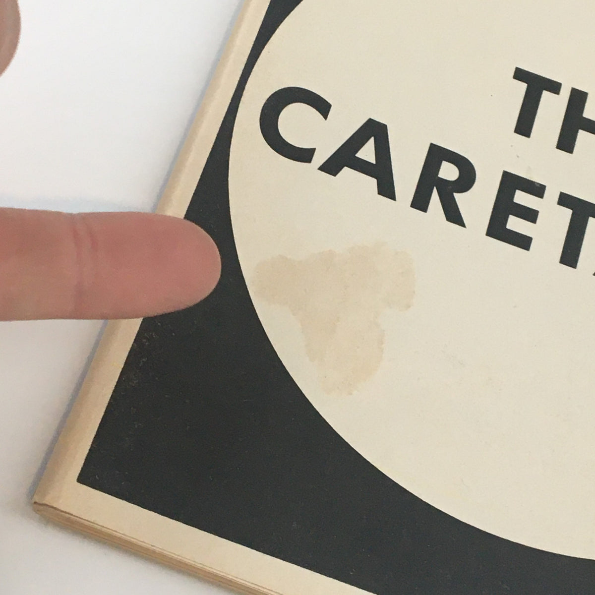 Close-up of the front cover of the 1986 Playbill for Harold Pinter's The Caretaker, highlighting a stain.