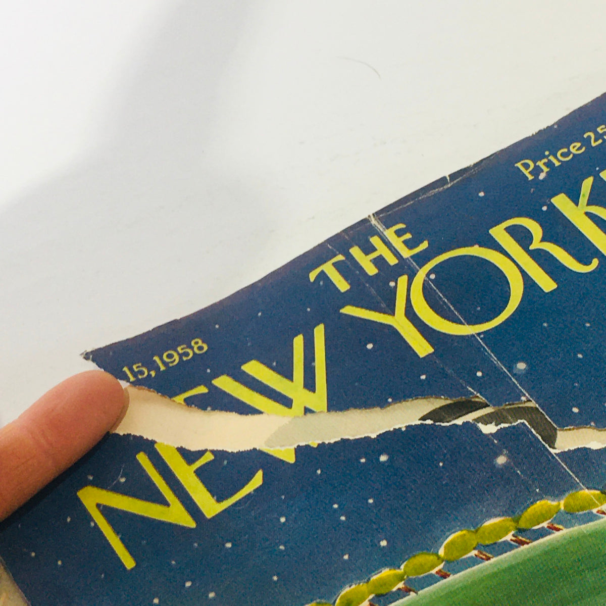 A close-up of the damaged cover of The New Yorker February 15, 1958 Full Magazine, revealing a tear and showing the magazine title and date.