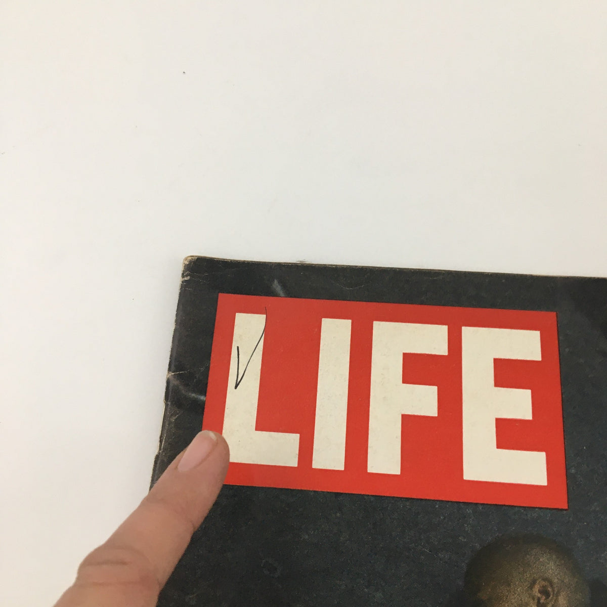 Close-up view of the cover of the vintage Life Magazine from July 28, 1967, featuring bold 'LIFE' lettering, highlighting the impactful title "Joe Bass Jr. Lies in Newark Street, Wounded," reflecting the historical events of the 1960s.