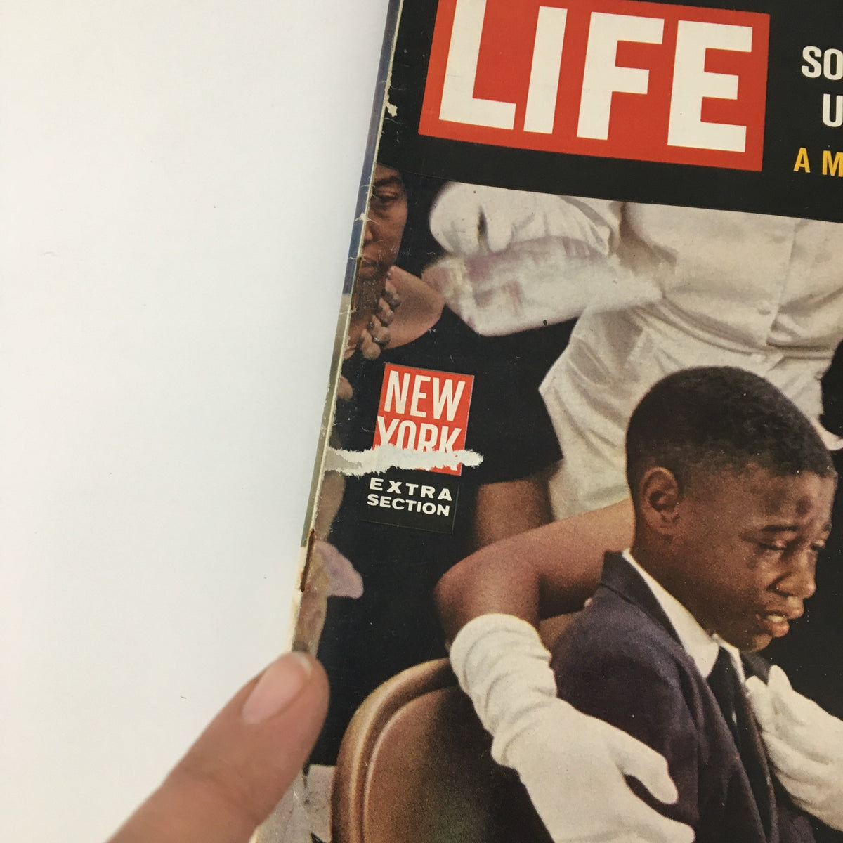 Close-up detail of the cover of VTG Life Magazine from June 28, 1963, displaying the title and the extra section label, focusing on Medgar Evers' widow and the emotional moment of comfort at a funeral.
