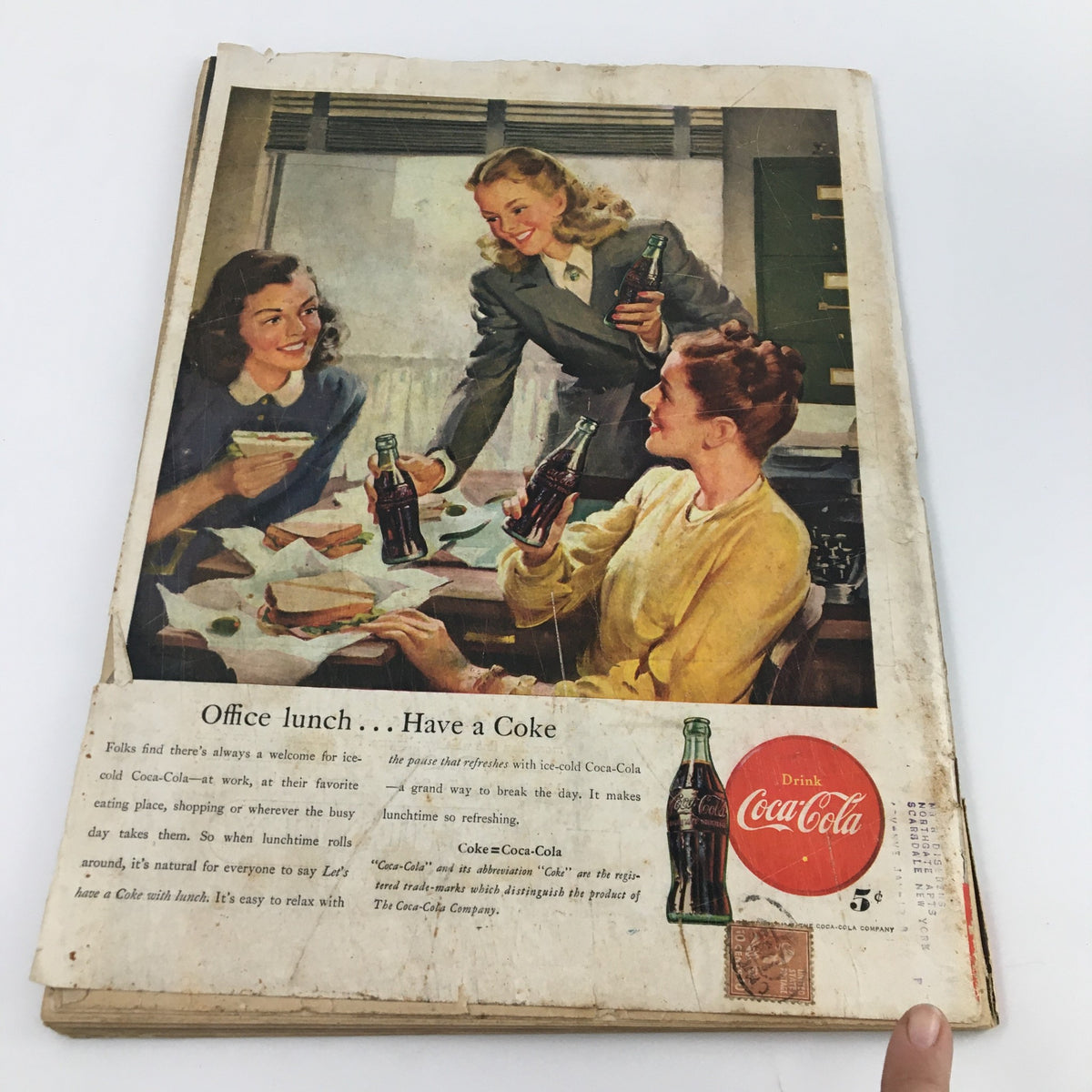Back cover of Life Magazine from April 7, 1947, featuring a Coca-Cola advertisement with three women enjoying drinks during an office lunch.