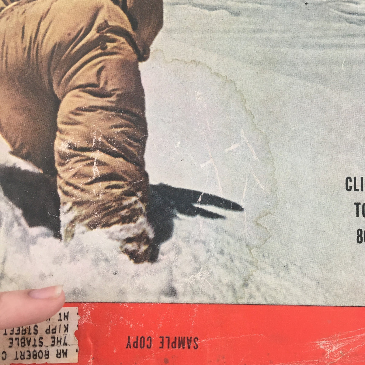 Close-up of the VTG Life Magazine cover from October 11, 1954, showing a climber's leg in snow and the sample copy label. The title reads 'Climber Founders Toward Victory, 800 Yards Away'.