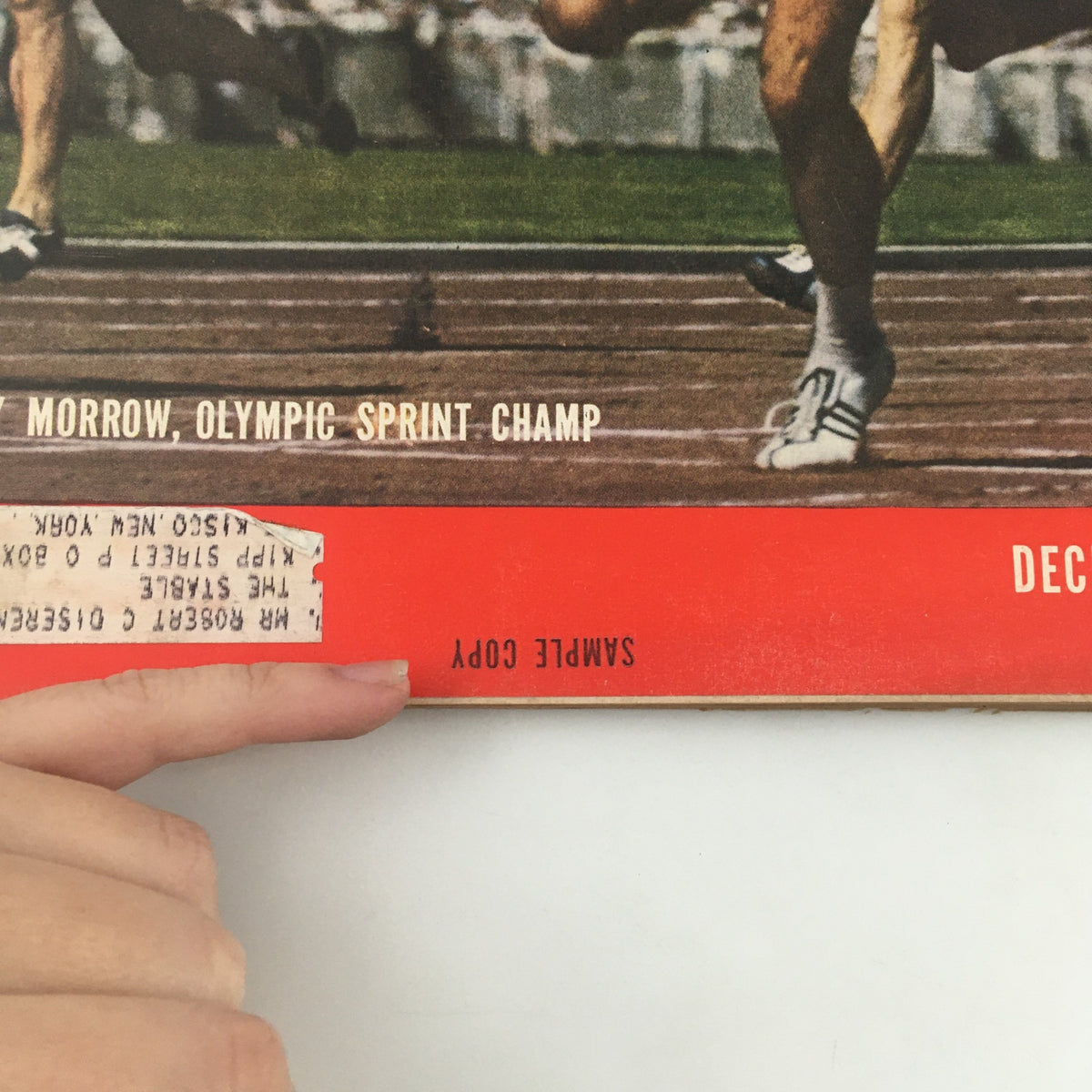 Close-up of the cover of Vintage Life Magazine December 10, 1956 highlighting Bobby Morrow, Olympic Sprint Champion, and the 'Sample Copy' label.