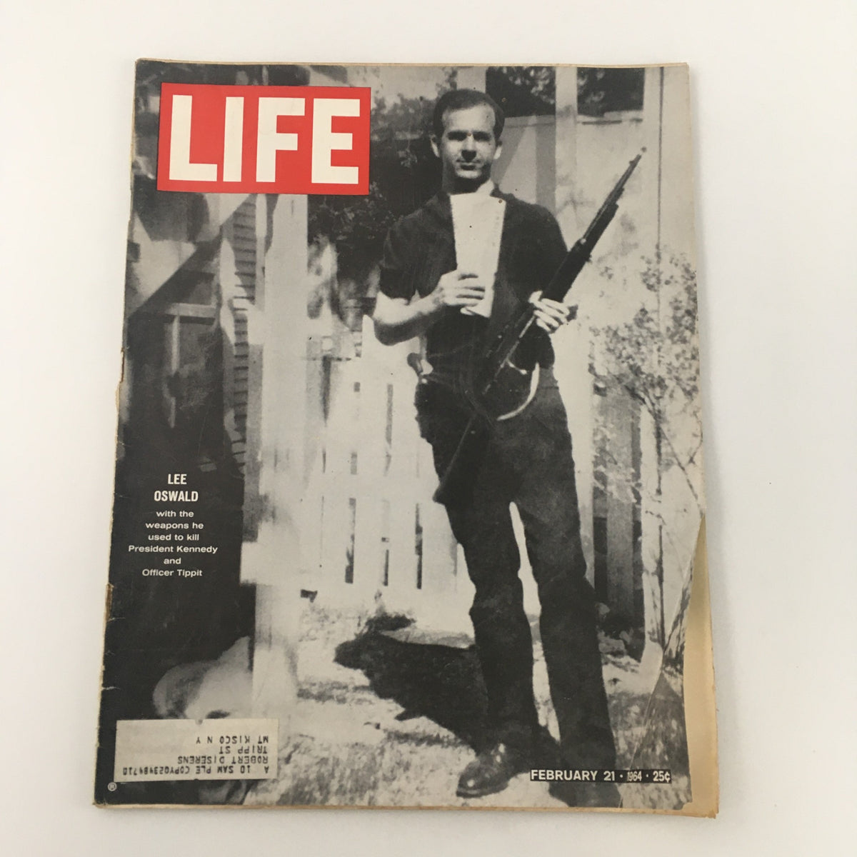 Vintage Life Magazine cover from February 21, 1964 featuring Lee Harvey Oswald, the assassin of President John F. Kennedy, holding a rifle.