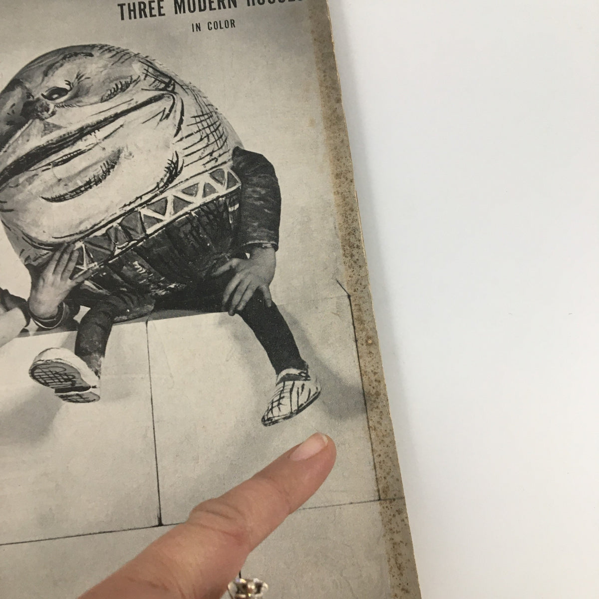Close-up view of the cover of Life Magazine April 28 1947 highlighting 'Three Modern Houses in Color', focusing on the whimsical character with a large head and pointed footwear.