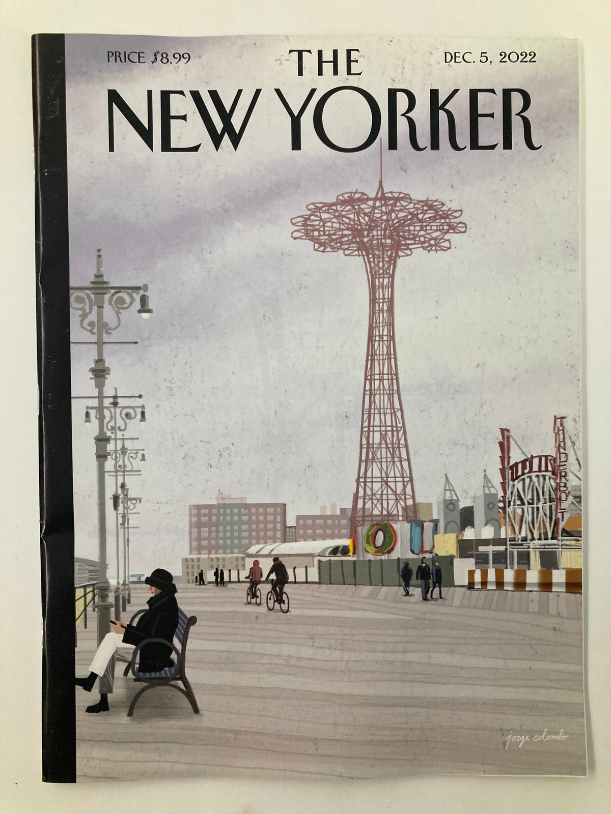 The New Yorker Full Magazine December 5 2022 Off-Season featuring cover art by Jorge Colombo, depicting a serene boardwalk scene with a vintage amusement park and a towering landmark.